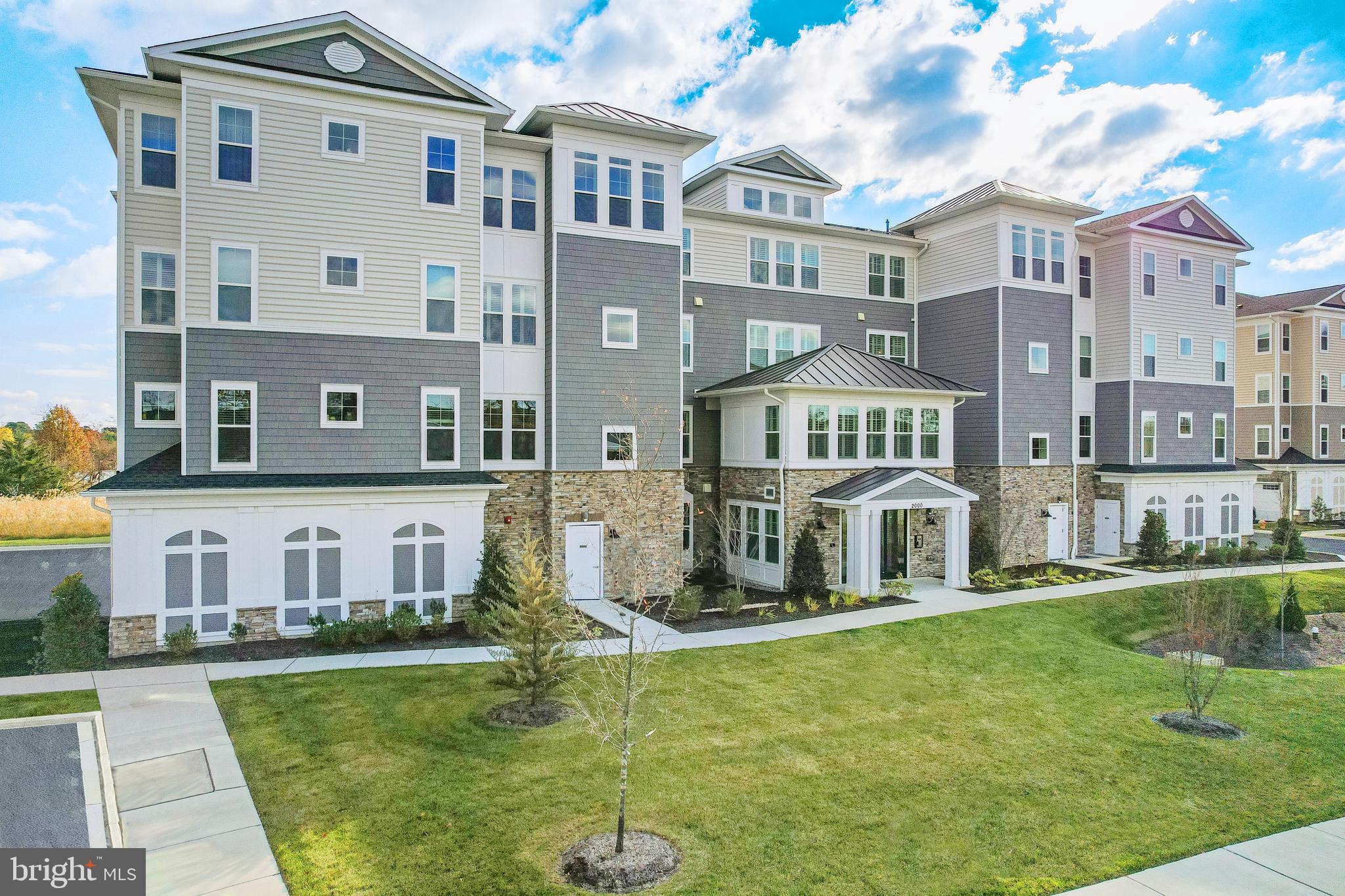 This home is under construction and will be move in ready by early 2024!  This home is located on the 3rd floor of the condo building and features a fireplace, dry bar, laundry cabinets and flooring upgrades.  For a full list please contact our sales representatives.
Welcome to a new luxury active adult 55+ community on Maryland's Chesapeake Bay. Discover the amenity-filled, resort-style experience within 45 miles of Washington DC and Baltimore. Residents can take advantage of the community's 24,000 sq. ft. clubhouse with indoor & outdoor pools, a state-of-the-art fitness center, and multiple tennis and pickleball courts. With a full-time lifestyle director on site the community also features a well-maintained calendar of activities such as walking club, indoor and outdoor yoga sessions, mahjong club, kayaking, pickleball and more. Kent Island life is about making friends and enjoying the company of people who have worked hard and now want to enjoy all that a luxury 55+ community has to offer. Located steps from the water and minutes from Annapolis,  the location also offers quick access to Rt. 50. Enjoy the convenience of nearby dining and shopping options together with the quaint charm of a small town. *Photos are of similar home as this home is to be built.