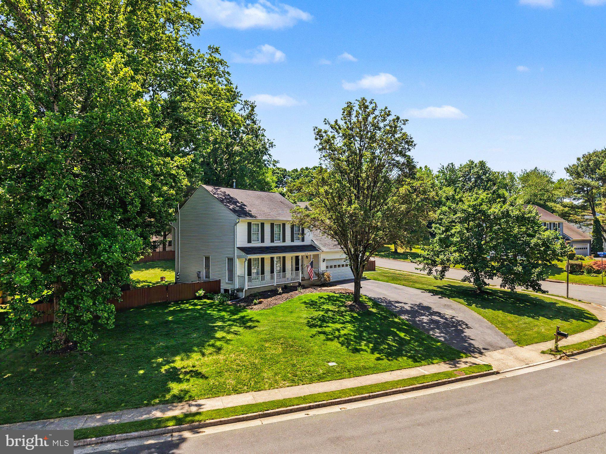 Beautifully updated and move-in ready in sought-after South Run Oaks, this Fairfax Station home is tucked away on a quiet double cul-de-sac with no thru traffic and sits on over a third of an acre with a fully fenced flat backyard. From the welcoming front porch to the TREX deck, updated white kitchen, rich hardwood floors, and spacious finished basement, this home offers the perfect combination of comfort, updates, and location.

Step inside and immediately notice the beautiful dark hardwood floors flowing throughout much of the home. The fully renovated white kitchen features tall cabinetry, an island, pantry, stainless steel appliances, and a sunny breakfast area overlooking the backyard. Just off the kitchen is the oversized family room with a gas fireplace and two sliding glass doors leading directly to the deck, creating a great flow for everyday living and entertaining. Separate living and dining spaces at the front of the home offer additional flexibility and natural light throughout.

Upstairs are 4 spacious bedrooms, including a large primary suite with a spa-like renovated bathroom featuring dual vanities, a soaking tub, oversized shower, slate flooring, and a built-in wall safe. The hall bathroom has also been updated with newer finishes and vanity. One secondary bedroom is especially large and would make an ideal office, playroom, or flex space.

The fully finished lower level offers even more living space with a large recreation room, bonus room/office, half bathroom, and an oversized laundry room with extensive cabinetry and extra storage space.

Major updates include the roof (2015), HVAC (2017), and hot water heater (2019). Located in the highly desirable South Run Oaks neighborhood, residents enjoy easy access to trails leading to Lake Mercer and Burke Lake Park, nearby soccer fields, basketball courts, playgrounds, and optional community pool memberships. Zoned for Silverbrook Elementary and South County High School pyramid schools and conveniently located near Route 123, Fairfax County Parkway, commuter lots, Metro access, Fort Belvoir, and the The Pentagon.