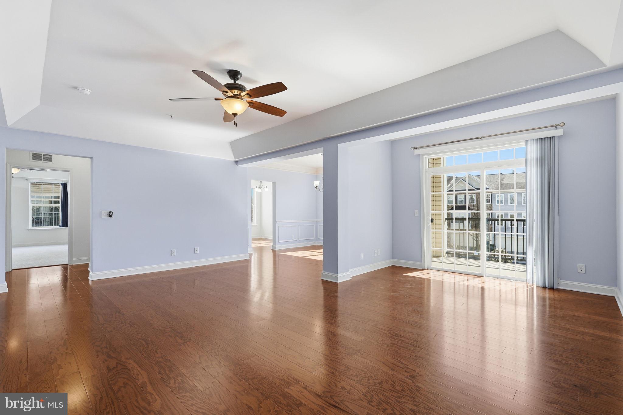 Recently renovated 3 Bedroom/2 Bathroom condo in The Gatherings of Wellington, a 55+ community located in Manassas City. Attached one-car garage and driveway. Dedicated, secure, storage is about 12'x8'. Main entrance lock at the lobby and elevator.  Unit is located on the second floor and is a corner unit offering a covered balcony.  Recently updated to include new flooring and fresh paint.  Hardwood floors start at the Foyer and run throughout the Living Areas and Kitchen. Separate Laundry Room off the Foyer has a Washer and Dryer plus wire shelving. Open Living Room features a ceiling fan with light,  tray ceiling, and sliding glass door to the covered balcony.  Separate Dining Room off the Living Room has chair rail, box trim, ceiling light and a double window.  Eat-in Kitchen features upgraded 42" cabinets, stainless steel appliances, gas cooking, granite counters, pantry and breakfast bar as well as a Breakfast area with windows on two sides and ceiling light. Sun-filled Primary Bedroom has brand new carpet, four windows, ceiling fan with light, walk-in closet and an attached Primary Bathroom featuring upgraded ceramic tile flooring, recessed lighting, grab bars, double sink vanity, walk-in shower stall and soak tub. Second and third bedrooms both have carpet and ceiling lights. Full, hall, Bath has ceramic tile flooring and shower/tub with tile surround and grab bars.  Community is conveniently located to shopping, restaurants, Old Town Manassas, VRE/Amtrak and so much more.  Community offers tennis courts, fitness room, community area and BBQ patio.