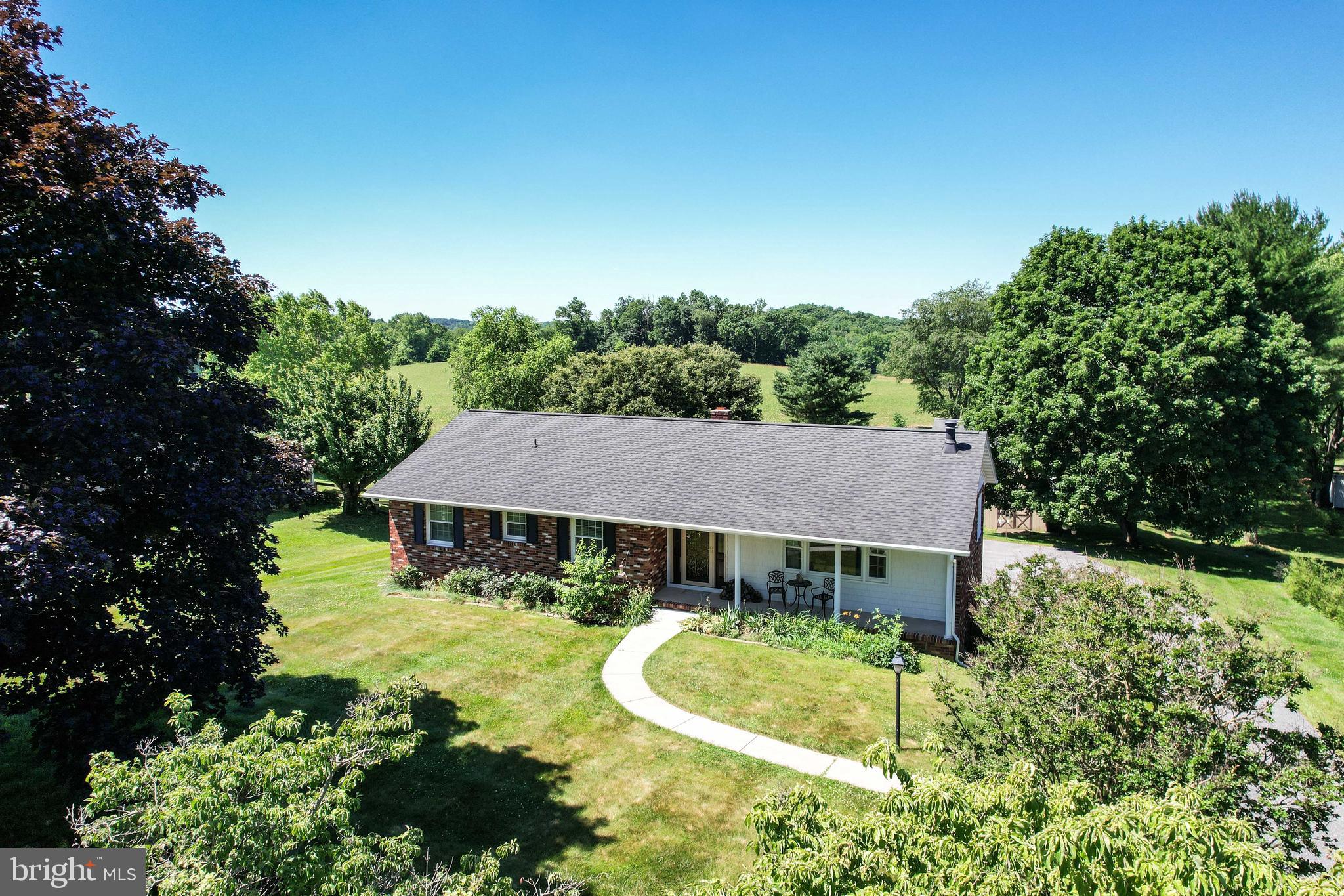 *Welcome to this beautiful 3BR 2.5Bath rancher in Finksburg, beautifully buffered by open farmland & peaceful country views*Enjoy the privacy & scenic backdrop that makes this setting truly special*This well-maintained home offers classic construction, an easy to maintain yard and thoughtful updates throughout*An oversized newer asphalt driveway provides abundant parking & leads to a spacious 27' x 24' detached two-car garage—ideal for vehicles, hobbies, or additional storage*Enjoy relaxing outdoors with your spacious covered patio or have plenty of extra parking space for a camper or other recreational vehicle*Step inside to a welcoming slate foyer which flows into the  living room which features real oak floors & a cozy wood-burning stove*Recessed lighting enhances the bright, comfortable feel throughout the home*The main level dining room flows seamlessly into the updated kitchen complete with ceramic tile flooring, stainless steel appliances, 42-inch cabinets, & generous workspace for cooking or entertaining*This level also includes a primary bedroom which leads into a luxuriously updated full bath with large glass shower, heated ceramic floors, & update high end cabinetry*Two additional bedrooms buffered by a "Jack & Jill" style full bathroom complete this level*The finished lower area expands your living space with a recreation room, a separate family room area, a bonus room (ideal for a music studio or home office) & a lower-level half bath*This level is perfect for entertaining, relaxing, or flexible living needs*Major updates include new luxury vinyl flooring on the lower level, newer primary bathroom remodel, architectural shingle roof (approx10 years old), newer double-pane double-hung vinyl-clad windows, & a newer gutters with gutter guards for low-maintenance exterior care*Leased Solar City/Tesla solar panels contribute to energy efficiency and long-term savings*If you’re looking for one-level living with bonus finished space, a detached two-car garage, modern updates, and a peaceful country backdrop, this Finksburg rancher delivers space, functionality, and charm in a beautiful rural setting*