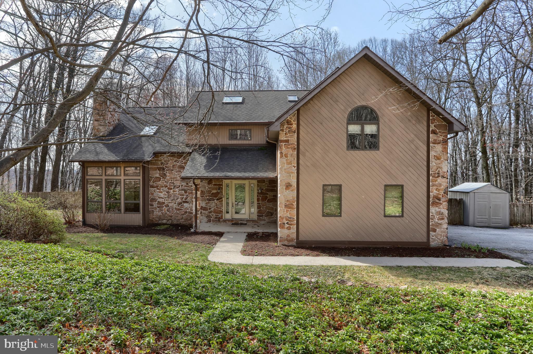 ** Offer Deadline Set - Monday 4/7/25 @ 4pm **  Tucked away on 4 private acres, this serene home offers privacy and tranquility in the woods of Spring Hill Acres. The two-story living room features a cozy fireplace, while the eat-in kitchen sits between the kitchen and family room, creating a warm gathering space. 
The home boasts three oversized bedrooms, including a primary suite with an attached finished bonus room above the garage, perfect for an office or den. The finished walk-out basement with a full bath adds flexible living space. Enjoy the fenced-in yard and peaceful surroundings. A true woodland escape, yet conveniently located. Schedule your private showing today!