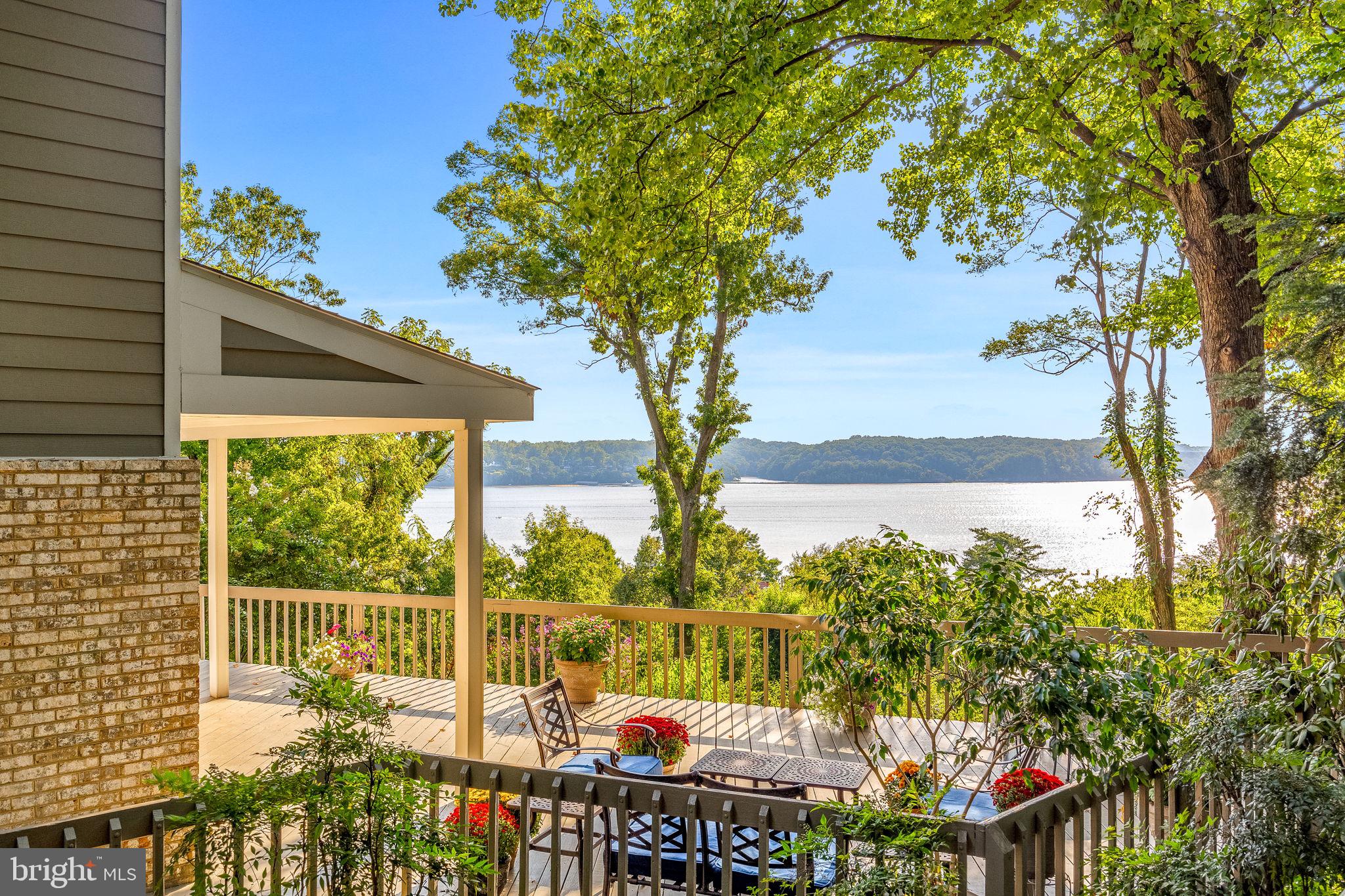 Enjoy a custom built, contemporary home perfectly situated in the heart of highly coveted Rugby Hall Estates with sweeping, expansive water views of the Severn River, This home offers peace and tranquility on a 1+ acre private lot nestled among magnolias, boxwood, nandina and crepe myrtle. With almost 5,000 sq ft of finished living space across 4 levels, there is space for everyone, offering 6 bedrooms with 4 full and 1 half bathrooms. Floor to ceiling windows maximize your view, coupled with glass door entry to the wrap around deck for seamless entertaining indoors and out. Enjoy summer nights on the side screened in porch with views of the lush grounds, gardens & the river. From the deck, the living room or the 3rd floor bedrooms, you can enjoy unparalleled sunsets over the river or have a front row seat to the Sherwood Forest fireworks and the weekly sailboat races.  Open concept main level has a gourmet kitchen offering stainless steel appliances, a large center island with seating and open to the dining area and living rooms beyond and provides plenty of space for entertaining. A wood burning brick fireplace brings cozy warmth  when the weather gets chilly. Custom main level mudroom offers wonderful built-in storage, laundry and a bonus freezer to make entertaining a breeze. The lower level is spacious with a living room, bedroom, full bathroom plus an apartment with separate private access ideal for in-laws or an au pair. The apartment includes a kitchenette, living area, separate bedroom and private bath with windows that look out over the river.  As an added bonus- this level is fully handicapped accessible, complete with a 4 stop elevator to the 3 main floors and direct access to the driveway! The 3rd floor bedroom level offers a primary retreat maximizing views of the river including an upper level private deck. Ample space with dual walk in closets and a private bathroom with tiled shower, soaking tub and dual sink vanity.  Three additional bedrooms and a large hall bathroom complete this level. The upper 4th floor level includes a spacious room for an office, playroom or 7th bedroom and an additional storage room. There is no shortage of space. Enjoy the water privileged lifestyle along the Severn River with many amenities at the Rugby Hall marina just a short walk away- deep water pier, boat slips, ramp, pavilion, playground, volleyball and much more. Severna Park Schools!
