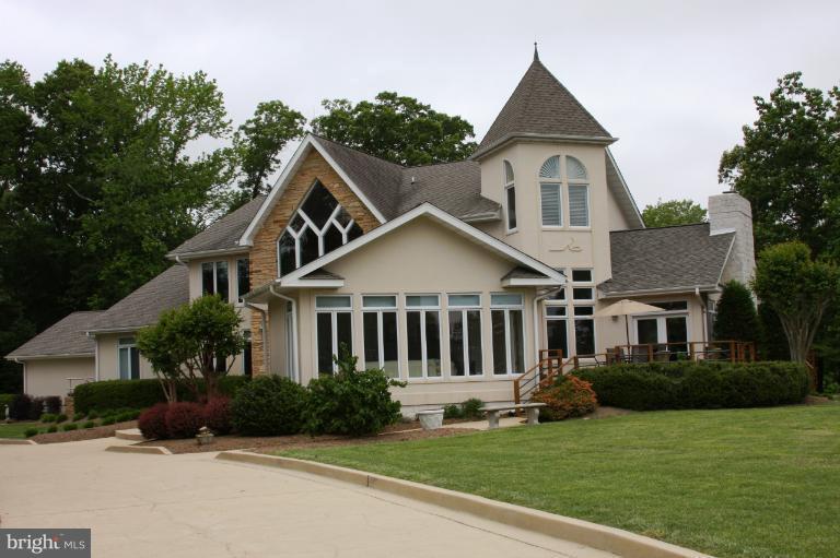 BEAUTIFULLY UPDATED CONTEMPORARY HOME W/ OVER 6000 SQ FT.  WATERVIEW OF PATUXENT RIVER & SMALL LAKE.   OPEN FLOWING FLOORPLAN W/ GRANITE COUNTERS THROUGHOUT, SS APPLIANCES,  CERAMIC FLOORING, MASTER BEDROOM WING FEATURES SITTING ROOM, WET BAR, FIREPLACE & MASTER BATH. WARM HARDWOODS  LOWER LEVEL PLUS A FLOOR TO CEILING STONE FIREPLACE! FABULOUS SUNROOM & EXPANSIVE DECKING GREAT FOR ENTERTAINING!