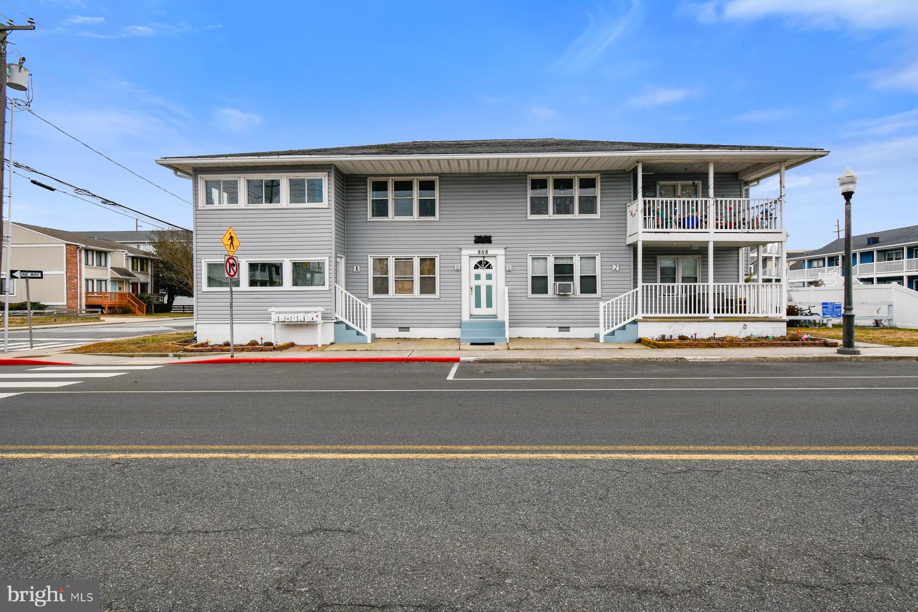 Step into this unique three-bedroom condo just three blocks from the beach and the 9th Street bathhouse, with less than half a block to the bay. A true beach lover's dream and an early Malibu-like beach house, it features stunning knotty pine walls, beautiful hardwood floors including under the carpet in bedrooms one and three), a recently renovated kitchen and bath - perfect for entertaining -- and an outdoor shower for rinsing off after a day at the beach.  Enjoy sunsets from the enclosed porch (with removable windows for that great beach air), which can also easily be used as a dining room, or host a barbecue in the central courtyard. Perfectly located within biking or walking distance from several restaurants, boardwalk, summer fireworks, movie nights, playgrounds, and pickleball, this property offers incredible investment potential as a vacation rental or full-time residence. This property has additional attic space for owner's personal belongings.  Don't miss this opportunity - it won't last long!