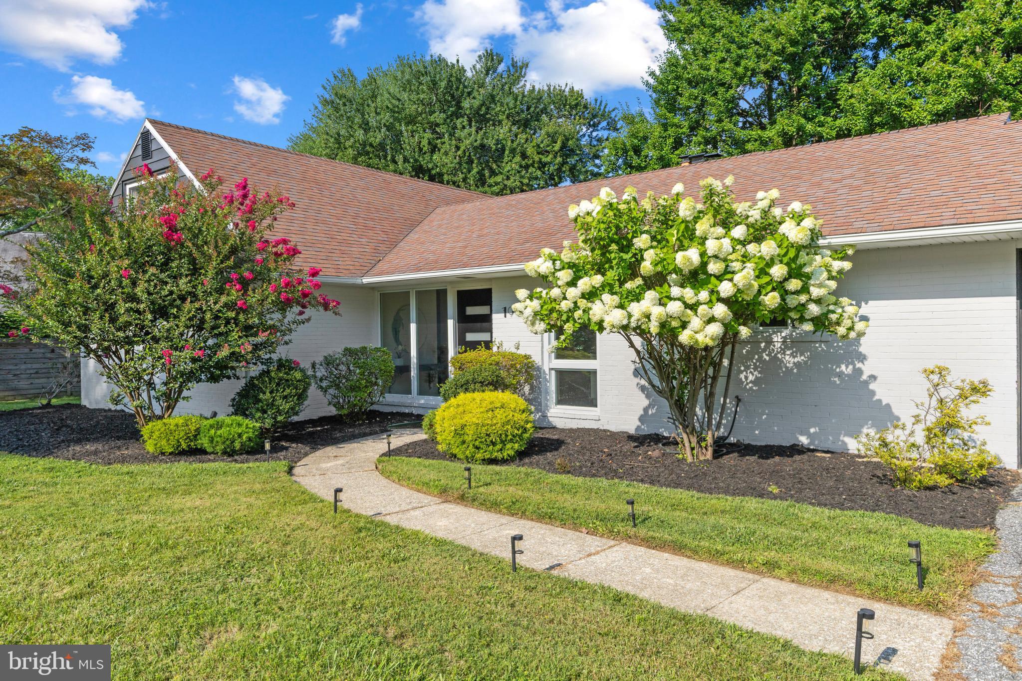 Recently renovated, this stunning mid-century modern ranch offers timeless architecture, contemporary finishes, and effortless main-level living in a picture-perfect, ultra-convenient neighborhood of Pikesville. Nestled on a lush green lot on a quiet, tree-lined street, the curved walkway and newly landscaped flowerbed lead you to the front door. From the entryway, you’ll be wowed by the spectacular gourmet kitchen featuring sprawling quartz countertops, a stylish backsplash, abundant cabinet storage, and brand-new stainless steel appliances that include a French-door refrigerator and electric stove with two ovens. Whether you’re seeking prep space to cook for a night-in, or hosting friends, the central island delivers with its expansive countertops, built-in wine fridge, and place for stool seating. The kitchen overlooks a combined living room and dining space, each with its own fireplace, allowing everyone to stay connected. From the dining area, handsome glass French doors segue into a radiant sunroom with windows on three sides, allowing you to soak up the serene backyard. Whether you're savoring your morning coffee here, getting lost in a good book, or simply taking in the peaceful view, this is a space you’re sure to enjoy.  The backdoor transitions onto a rear patio ideal for outdoor dining and relaxed evenings with family and friends. When it’s time to tuck in, you’ll love the spacious Primary Suite flaunting an entire wall of closet space and an impressive ensuite full bathroom complete with a soaking tub, separate shower, linen closet, and large vanity. Two additional generously sized bedrooms provide flexibility for guests, hobbies, or a home office, while a well-appointed full hall bathroom is easily accessible to the secondary bedrooms and living space alike. The attached two-car garage has interior access to the kitchen and exterior access to the backyard; it offers room for vehicles, extra storage, or the opportunity to create additional finished living space to suit your needs. Need more storage? The large attic offers plenty of space for you to easily stow your items out of sight! Beautifully reimagined, 7900 Ivy Lane delivers the rare combination of architectural character, thoughtful renovations, and turnkey convenience in one of Pikesville’s most picturesque neighborhoods; make it yours today!