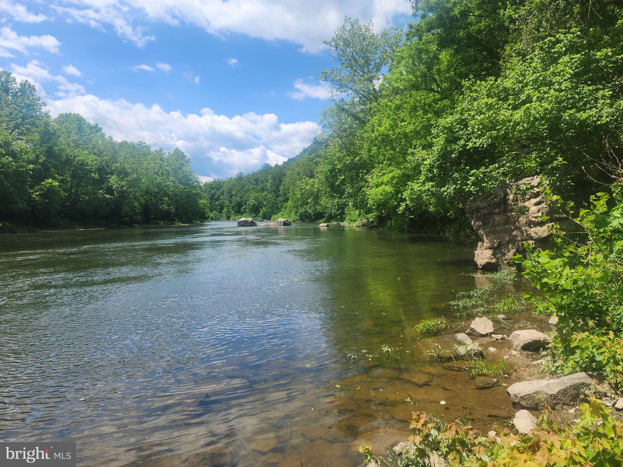 CALL IT A UNICORN, A FLYING PIG, OR JUST A RARE FIND.  WHATEVER YOU CALL IT,  YOU CAN REST ASSURED THAT YOU WON'T BE DISAPPOINTED IN THIS 10 ACRE  !!UNRESTRICTED!!  PARCEL WITHIN EARSHOT OF THE SOUTH BRANCH OF THE POTOMAC RIVER.  THIS UNIQUE LOCATION CAN BE FOUND AT THE BASE OF WHITEHORSE MOUNTAIN NESTLED BETWEEN 2 PUBLIC ACCESS POINTS TO THE RIVER.  THE SOUTH BRANCH IS WELL KNOWN FOR IT'S BEAUTIFUL FLOAT TRIPS BY TUBE OR KAYAK, TREMENDOUS  SMALL MOUTH BASS FISHING, AND WONDERFUL SWIMMING HOLES.  JUST IMAGINE OWNING YOUR OWN PROPERTY SMACK DAB IN THE MIDDLE OF IT ALL.  DUE TO THE DISTINCTIVE HORSESHOE BEND IN THE RIVER,  YOU CAN LAUNCH YOUR BOAT OR KAYAK AT ONE ACCESS, FLOAT FOR 3 HOURS, AND TAKE OUT A MILE FROM WHERE YOU PUT IN.  THIS PROPERTY EXISTS ALONG THE ROAD BETWEEN THOSE 2 ACCESS POINTS MAKING IT SUPER CONVENIENT FOR ANY AND ALL RIVER ADVENTURES.  THE PARCEL FRONTS ON A PAVED, STATE MAINTAINED, DEAD END ROAD AND COMES WITH A RECENTLY INSTALLED DRIVEWAY AND BUILD/CAMP SPOT.  FROM HERE YOU CAN HIKE UP TO THE ROCK CLIFFS AT THE TOP OF THE PROPERTY,  AD SOME ATV TRAILS, SHOOT, HUNT, OR JUST SIT AND TAKE IN THE PEACE AND QUIET. THE CHOICE IS ALL YOURS.  NOW IS THE TIME TO CARVE OUT YOUR OWN PRIVATE RECREATIONAL PARADISE IN THE MOUNTAINS OF "ALMOST HEAVEN".  PLAN A VISIT TODAY!