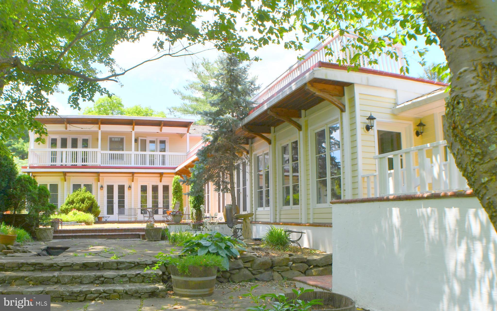 This beautiful  8+ acre property has a 4,220 square foot custom-built-home with 5BR and 5BA.  Originally built for Mrs. A. C. Randolph, it was expanded in 1996 and renovated in 2016/2017. The materials used in the original construction were of the highest quality (for example, Marvin Window and Doors, cedar shake roof).  The renovation in both the main house and the pool house duplicated that quality of materials. In addition to the main house, there is also a heated 2-car detached garage with a shelving support system installed on two walls and shelving on the third wall, two wooden sheds, a pond, in-ground pool, and pool house. Extensive hardscape and landscaping has been professionally planned and maintained.The house started life as a fairly traditional Rambler. A two-story addition was added on one end 24 years ago, giving the house an  L  shape.  The back of the house is lined with French doors and windows looking out to the Courtyard and filling the house with light.  Wood trim with high-quality detail give the house a warm and intimate feel.  It is extremely comfortable!  The first story has 4 large BRs, each with its own bathroom. A generous-sized spiral staircase in the family room comfortably whisks you up to a large bedroom and an office; the two are joined by a beautifully tiled full bath.  The office features a full wall of built-in bookcases and French doors leading to the covered balcony.  The view beyond the Courtyard below sweeps past gardens, a variety of mature trees, a small pond.  It ends at the full-sized, heated pool and Pool house, which reside in their own little oasis, surrounded by mature trees.  A pergola with grape vines enhance the large pool deck and invites lazy afternoons.  The Pool house boasts a 2-story family room wired for satellite TV, a kitchenette, a full bath, and-if needed-another bedroom. Behind the pool house is an approximately 3 acre field, ready for any use.  The entire property is surrounded by three-board fencing.Pictures do not do this property justice. One must visit it to experience the warmth and privacy it offers!