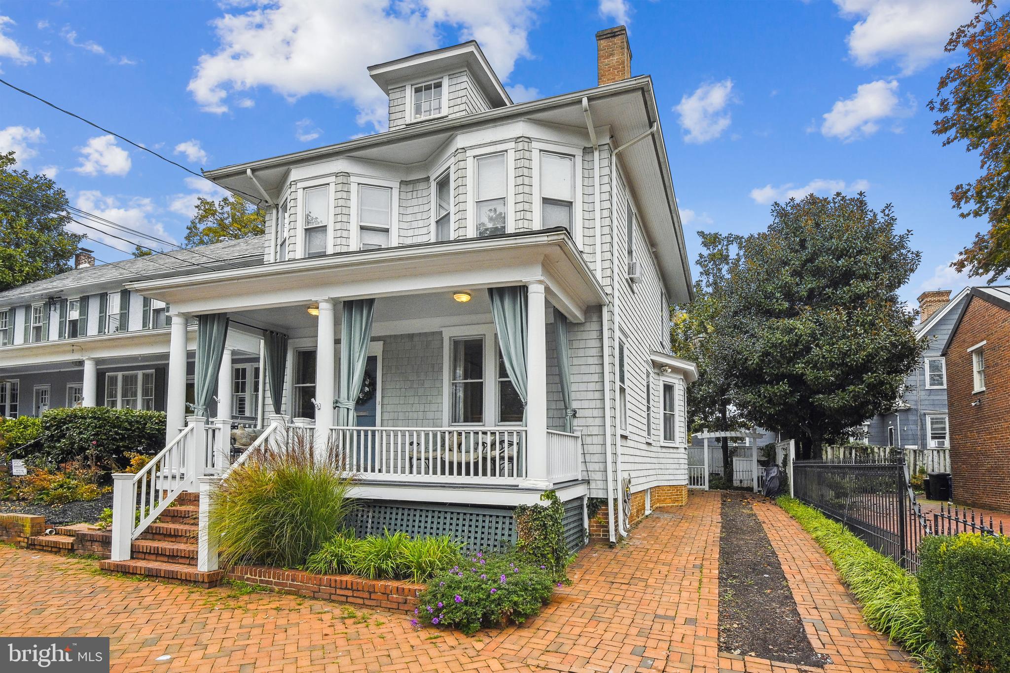 All the charm of a historic Annapolis home...but with all of the updates desired for modern living!  This unique property was gutted and completely renovated (2006-2007) on the inside, to include adding a fully finished lower level with high ceilings and a separate walk out entry and a spacious loft bedroom on the upper level. (PLEASE NOTE: the tax records do not reflect the actual square footage, please see estimated). The exterior was updated with shake siding and materials, while maintaining it's original look.  The welcoming covered front porch allows great space to sit and take in life in the city.  Walk into the gracious entry foyer that has custom designed inlaid wood floors and you will immediately be greeted with all of the natural light that comes in the home.  Exceptional, high-end finishes are present throughout, including recessed lighting on all 4 levels.  On the main floor, the living room has coffered ceilings and a custom built mantle around the gas fireplace, there are chair moldings in the living room and the kitchen has been finished with custom cabinetry and built ins, an oversized island with plenty of seating, granite countertops, additional storage cabinets, a wine fridge, walk in pantry, six burner gas cooktop and premium brand appliances.  Rear French doors open out to the private fully fenced rear yard that has a tumbled stone patio, pergola and landscape lighting to enjoy relaxing meals outdoors or entertaining with family and friends. The second floor leads to the primary bedroom suite with a living area and walk in closet.  The primary bath includes built in cabinetry, a soaking tub and separate shower, toilet closet and custom tiling.  There are two additional bedrooms on this level, one with an ensuite bathroom and the washer/dryer closet is located in the hallway along with a separate linen closet.  The third floor loft  includes a full bath, closet and additional storage areas...it could be used as a bedroom, office or both.  The glass door opens to a rear deck and seating area that has lovely views of the Naval Academy Chapel dome.  Head downstairs to the lower level and there is a half bath, utility room and large cedar storage closet...the hall leads to a sunken living area and pool room with 9' ceilings, chair railings, custom built in cabinetry, wet bar and tile flooring.  Coveted off street parking is included...the brick driveway on the right side of the home allows for 3 cars!  INVESTOR ALERT:  Currently in use as an Airbnb property that has provided a generous income flow for the current owner (additional information available). This one of a kind property is located just steps away from the US Naval Academy and historic downtown waterfront, restaurants, shops and all Annapolis has to offer...LIVE, WORK, PLAY!!!