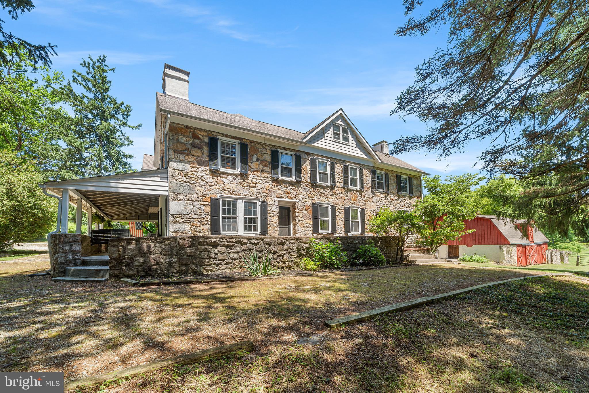 The original portion of the farmhouse was first constructed by James Sloan in 1811. Three generations of the Sloan family worked the land and lived on the farm. The farm was acquired in the late 19th century by Francois and Marie Supiot. The Supiot’s emigrated from France with their five children and settled in Philadelphia. They were farmers, and brought many new & unusual varieties of plants to the United States. Its namesake was Lilac Farm, as they imported many unique varieties of French lilacs that were until then, unavailable.  One of the remnants of the original farm is an amazing stone & brick round chimney that used to provide the exhaust to the heating system that kept the lilacs blooming, even during the winter months. The current owners constructed a 4-stall horse barn with tack room & hay loft. It is believed that the living & dining rooms are the original 1811 farmhouse. The living room has a beautiful fireplace and a set of built-in bookcases, windows overlooking the covered porch and the rear yard with direct access to the brick patio. The dining room has another beautiful fireplace, chair rails and two windows overlooking the back yard. Based on some of the moldings and the stair banister, the first expansion to the house was during the Victorian period. This added a central entrance hall with a gracious staircase, another living room with built-in bookcases and the 3rd fireplace. A full width porch was added. The central hall and the 2nd living room provide direct access to the front and side yards. The 3rd addition was the den that has the 4th fireplace, a wet bar and a door to the rear yard and brick patio. The kitchen was added by the current owners that incorporated a powder room and the 1st floor laundry. The structure was added in 1987, then the kitchen was remodeled once again in 2003 with fine custom Cherry cabinetry, a large central island and terra cotta tiled flooring. There is a set of French doors that lead out to another brick patio overlooking the yard and inground pool. Ascend to the 2nd floor, and there are three graciously sized bedrooms in the western wing of the home, along with a hall bath with a tub/shower and the most unique cross-hatched wood ceiling detail. In the hallway outside these rooms is a trinity staircase to the 3rd floor.  While in the past, some of the rooms on this level were finished as additional living space, today they offer an abundance of dry storage.  With little effort, they could be refinished to add a 5th or 6th bedroom. Back down on the 2nd floor, the primary suite incorporates a large sleeping chamber overlooking the rear yard, a large dressing room with ample closets and a renovated (2010) en-suite bath with a walk-in shower. There are three wall-mounted mini-split units on the 1st floor, and 3 more on the 2nd floor. The privacy of the property is amazing! With Valley Creek at the far southern end of the land, the only neighbor that is even visible in the winter time is up in front of the house. Even though you are surrounded by the privacy of woods and a stream, the development that began in 1967 provides for 20 neighbors. Now, you may think that you are still out in 19th century farmland when you are on the property, but modern life has approached the home in a good way. In 5 minutes, one has access to the Route 29 interchange for the PA turnpike to head East or West as well as the major business complex of the Great Valley Corporate Center. In another 5 minutes heading south, one has access to all the shops and restaurants along Lancaster Avenue. The George Lorimer Preserve is just around the corner, with 87 protected acres and 3+ miles of nature trails. There is also the Valley Forge National Historic Park which has protected over 3,500 acres of meadows, woodlands and historic monuments from the revolutionary war that’s just around the corner! Come discover Lilac Farm, and you too will be enchanted by the history & privacy!