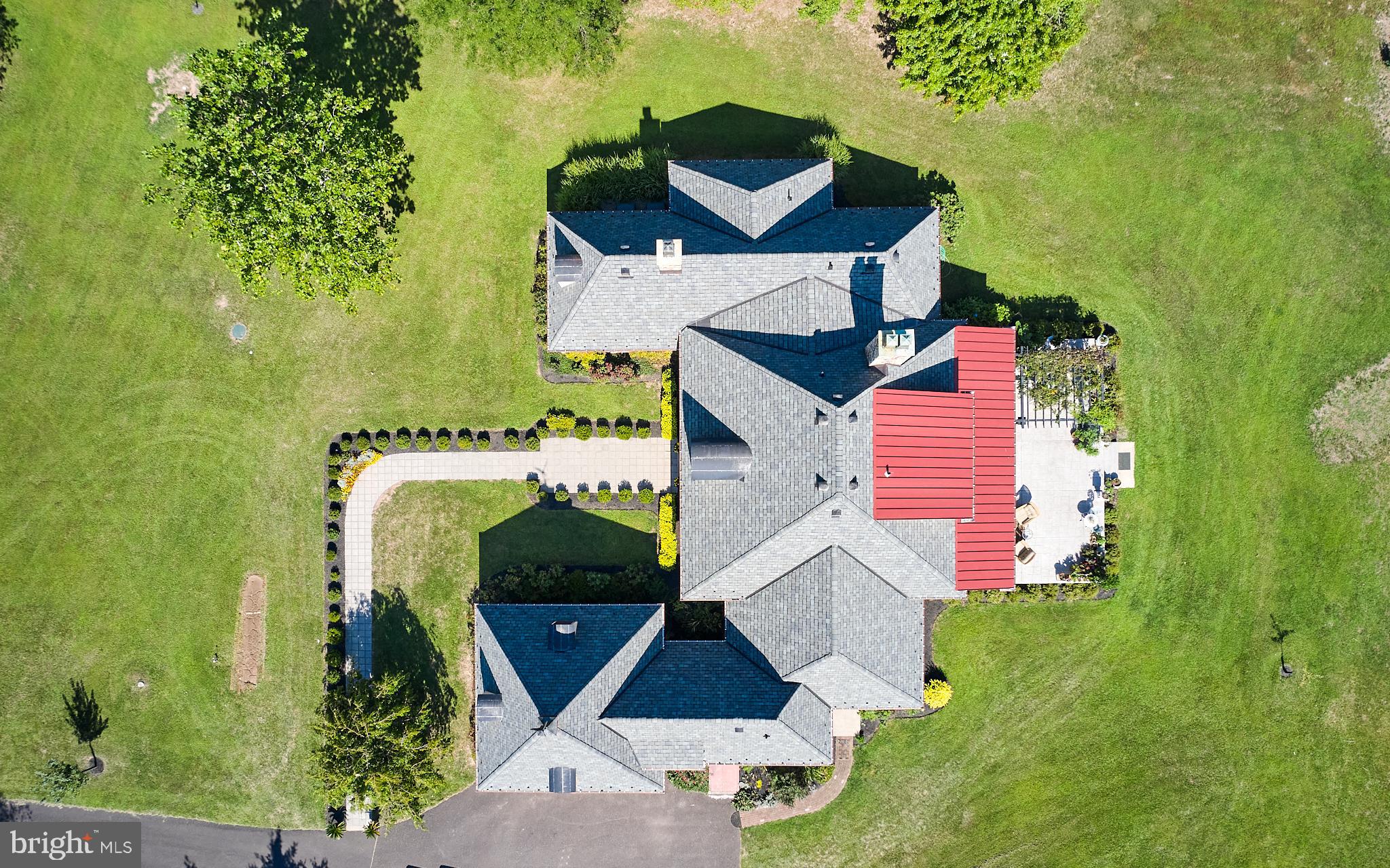 Within the peaceful countryside of Tinicum Township, is Barnstone, a stone manor house that reflects the architectural aesthetic of French Country at its best. Designed by architect Jack Arnold of Homes of Elegance, this luxury home was crafted for graceful living. Built of stone from a 150-year-old barn that once stood on the original farmstead, the home has a recent roof with a transferable 50-year warranty. 
The interior of the home has a logical floor plan that moves from the front foyer to the ample-sized dining room on the right and then straight back to the oversized Great Room, which has a wood-burning fireplace, extra wide crown moldings and a bar with wine refrigeration. A wall of glass doors is ideal for displaying the large entertainment patio beyond the open yard. The eat-in kitchen contains Ukrainian blue mica granite countertops, custom cabinetry and a chef's appliance package. There is a large pantry, powder room, and staircase to the au pair bedroom.
The main floor contains a reading nook overlooking the front lawn and the primary bedroom with a sumptuous bathroom. Just down the hall is the den/library for your entertainment and a second powder room is sensibly located.
The second floor has two family or guest bedrooms with two bathrooms.
The large basement is ready to be converted to a theater room, gym, or whatever your imagination conjures.
Barnstone is a refreshing change from the typical center hall colonial that is so plentiful in today’s market. Let your vision drift to the French countryside which will prepare you for an invigorating visit.   Within walking distance of Tinicum Park pickle ball, basketball and tennis courts and park swimming pool and hiking trails.