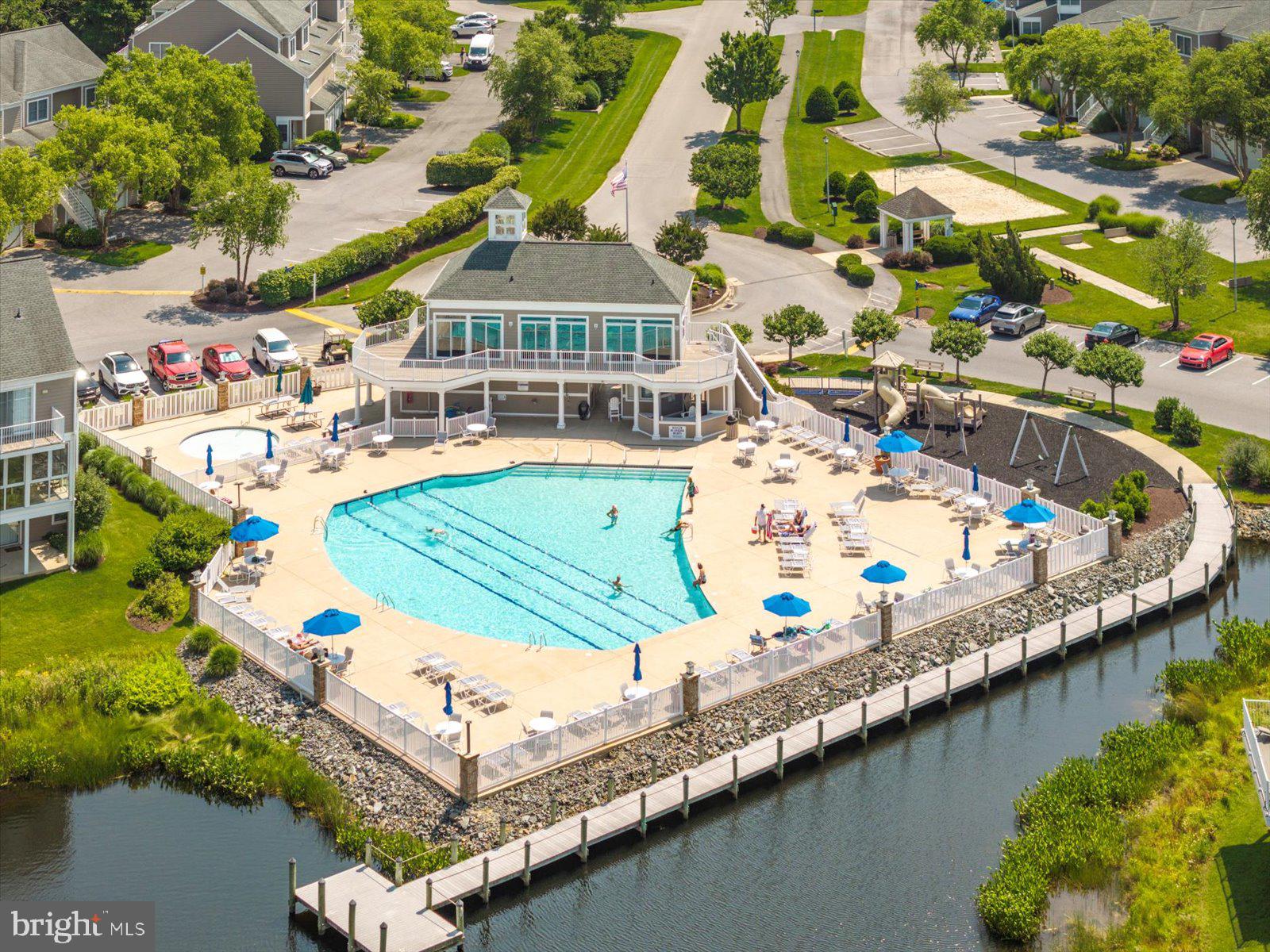 338312 Ocean Vista Drive #1082 in Selbyville, Delaware is a waterfront townhome in the desirable Bayville Shores community offering expansive views of the Little Assawoman Bay, surrounding wetlands, and the Fenwick Island skyline just minutes from the beach. This freshly painted 3-bedroom, 3.5-bath residence features a light-filled open-concept main level with detailed trim work and a spacious granite island kitchen designed for entertaining and easy coastal living. Sliding doors lead to an open waterfront deck where you can enjoy peaceful morning sunrises over the bay, coastal breezes, and ever-changing natural scenery. The upper level offers a generously sized primary suite with a private deck overlooking the water—an ideal vantage point for sunrise skies—along with exceptional closet space rarely found in similar properties, while an additional en-suite bedroom provides comfort and privacy for guests. The entry-level suite opens to a covered patio and green space, creating flexibility for visitors, extended family, or a secondary living area. A conveniently located laundry area and attached garage with added storage enhance everyday functionality and beach-day convenience. Ownership is designed for ease, with the HOA covering exterior maintenance as well as flood and hazard insurance, while water service is included and the home is connected to public sewer. Residents also benefit from low electric rates through Delaware Electric Cooperative, and Bayville Shores incorporates community solar that has generated more than 1.5 million kilowatt hours of energy over time. Community amenities include a private boat ramp, kayak and paddleboard launch, pool, tennis courts, and scenic walking paths, all ideally located between the Freeman Arts Pavilion and the beaches of Fenwick Island. Short-term rentals are permitted, making this property equally attractive as a primary residence, second home, or strong coastal investment opportunity. Updates include a new hot water heater.