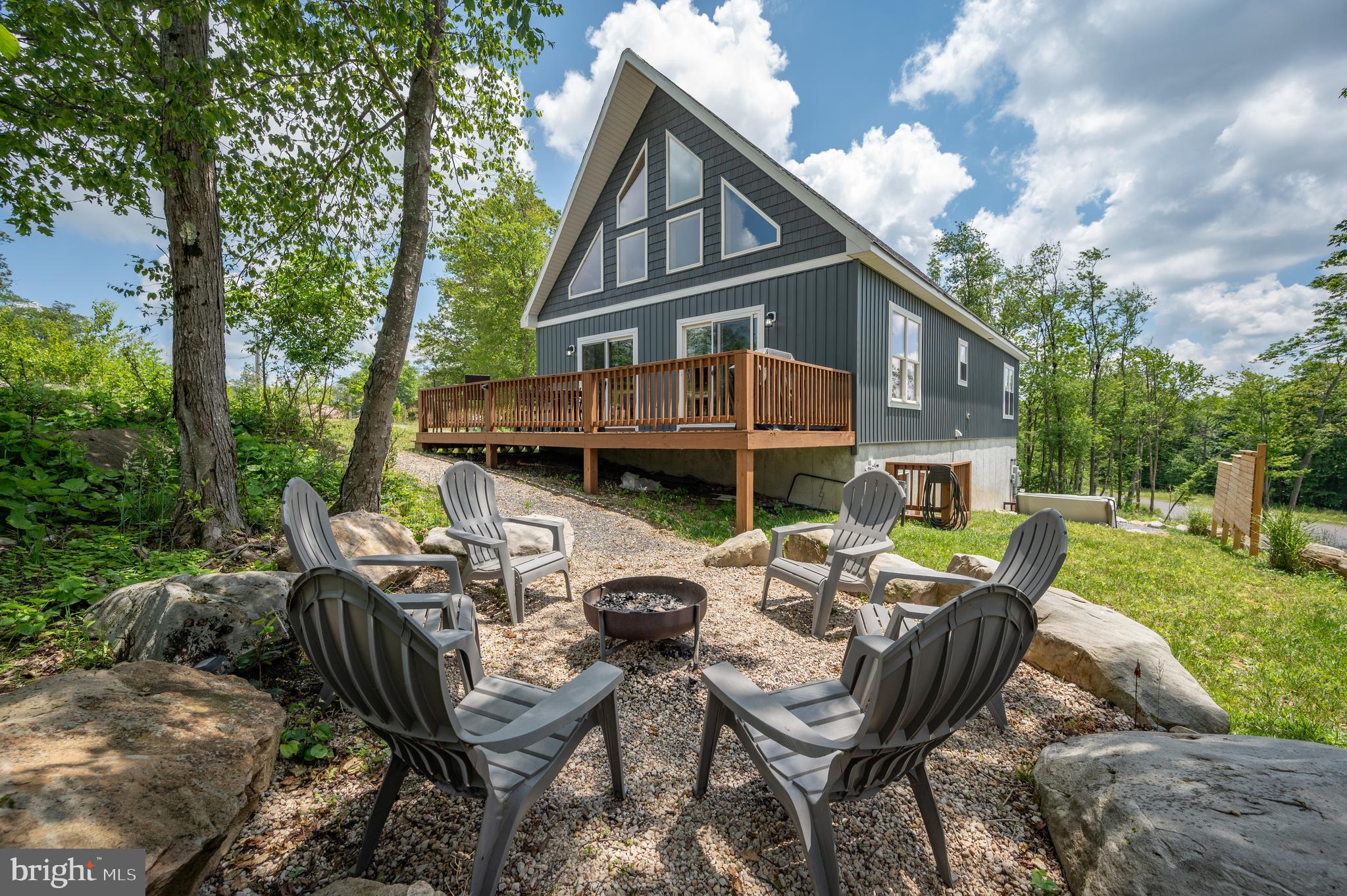 Modern Mountain Retreat at Wisp Resort—welcome to Wildwood Ridge. Built in 2021, this beautifully designed 5-bedroom, 4-bath chalet offers nearly 3,300 sq ft of stylish, turnkey living adjoining the slopes at Wisp Resort!
Set atop Wisp Mountain, the home combines adventure and relaxation in one unbeatable location. Enjoy easy access to Fork Run Recreation Area trails, mountaintop waterways, and scenic paths. Take in breathtaking sunsets and crisp mountain air right from your private deck.
Inside, the open-concept main level features vaulted ceilings, a cozy gas fireplace, and a spacious primary suite. Well-appointed kitchen with stainless appliances, granite countertops, and a clean, modern aesthetic, flowing seamlessly into the main living and dining areas—ideal for entertaining or everyday comfort. A second ensuite and loft overlook the great room above, while the walk-out lower level offers a second living space complete with a pool table and wet bar.
Thoughtfully furnished and sold turn-key, the home is designed for both relaxation and fun—unwind by the fire, enjoy movie nights in the lower-level den, or soak in the hot tub after a day of adventure. Whether you're seeking a strong vacation rental opportunity or your own private mountain escape, this property delivers the best of Deep Creek living just minutes from dining, state parks, and Deep Creek Lake. Call today for details!
