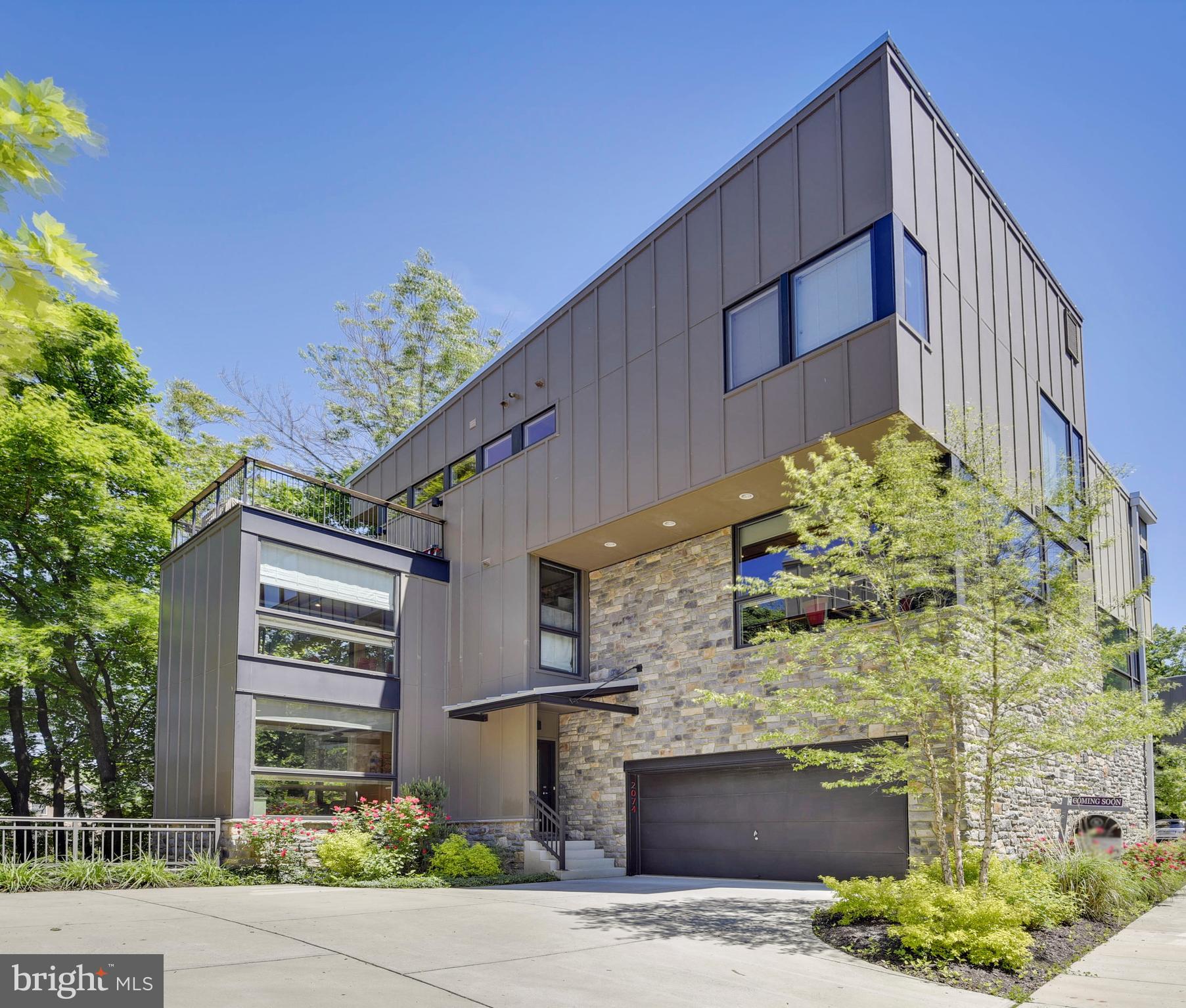 One of the best in Clipper Mill. Largest model available - true 4BR with over 3000 square feet of finished space. Award-winning design by Charles Alexander. Contemporary duplex with walls of windows. This one has WOW factor! Custom Artisan Interiors kitchen features Miele and SubZero appliances, oversized island with seating, and wine refrigerator. Open floor plan with walls of windows. 9 or 10 ft. ceilings throughout. Main level family room/office. Lower level suite with living area, bedroom, full bath and level outside entrance. Master BR has large walk-in closet, full bath with oversized shower, and access to roof deck. Patio + 3 decks for outdoor living. Zoned heating and AC. 2 car garage + driveway + permit parking. Built to LEED Silver standards with energy saving features throughout. HOA fee includes use of Clipper Mill pool. Adjacent to 750 acre park with serenity garden and hike/bike trails. ** SEE VIRTUAL TOUR for interactive floor plans and more photos. **