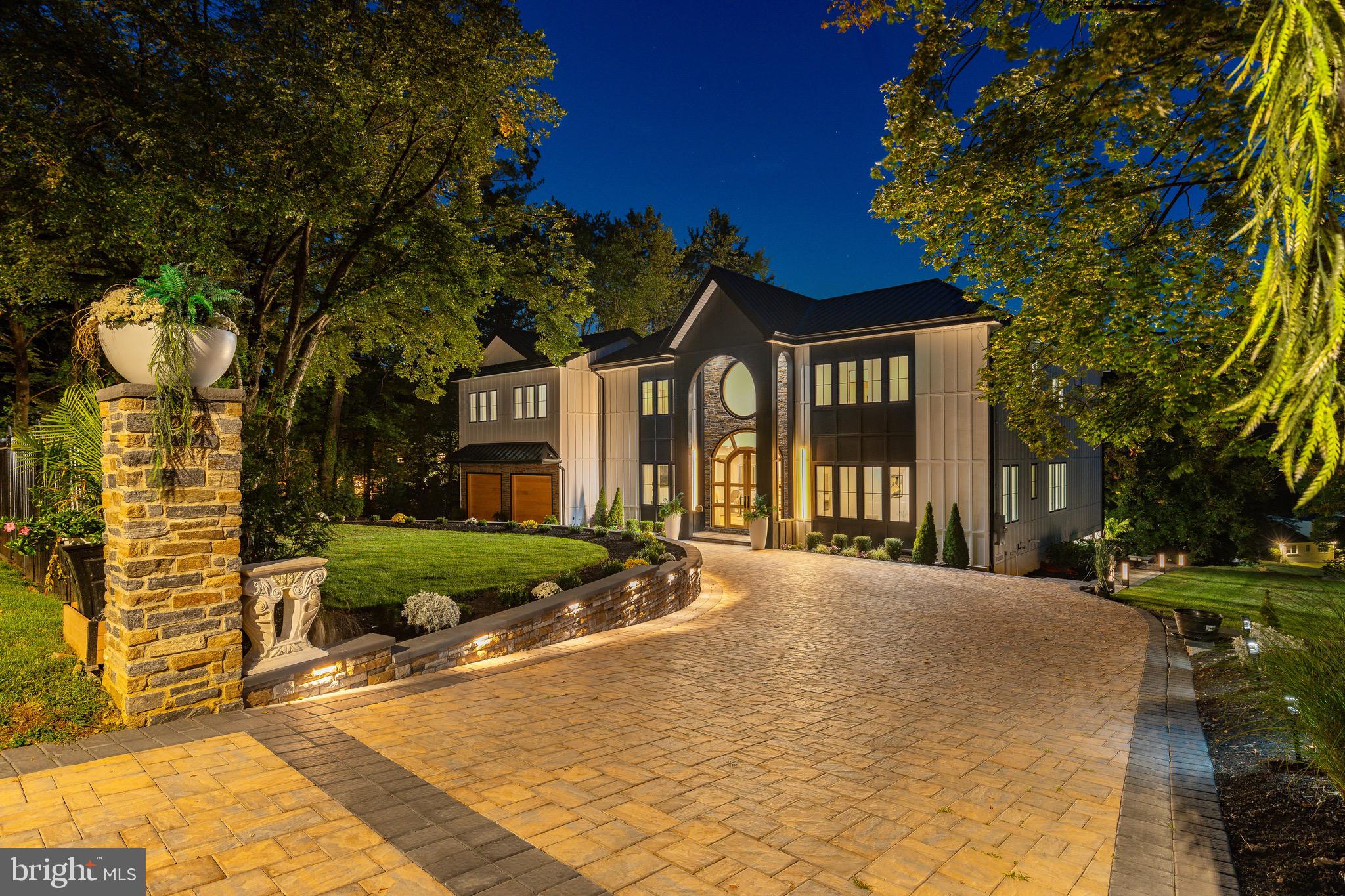 Enter into a world where soaring design, sweeping Arboretum views, and one of the largest backyard deck's in Chestnut Hill converge to create a once in a lifetime new construction home, crafted for today's sophisticated buyer. A long illuminated paver driveway framed by automatic smart gates creates a dramatic approach with generous space between neighboring homes and a backdrop of lush greenery, offering a rare sense of privacy and arrival. Inside, soaring 10 foot coffered ceilings, oversized doors and tall glass windows flood the interiors with natural light, while 10 inch wide plank character white oak floors, a sleek glass-railed illuminated staircase, and gallery-like sightlines create an unmistakable sense of modern sophistication. The chef's kitchen and living spaces flow seamlessly to an expansive 2,000-plus-square-foot Zuri backyard deck, perfect for year round entertaining and taking in the treetop views. Four ensuite bedrooms and a versatile office or library offer private retreats, while the lavish primary suite impresses with a 16 foot cathedral ceiling, spa-inspired bath with dual glass showers, soaking tub, sauna, four skylights, and dual custom closets. The finished 1,700-square-foot lower level offers endless potential including the option for a guest suite or additional living space. Completing this remarkable home is a two-car garage with custom hardwood doors, smart openers, soaring 12-foot ceilings and its own mini-split system for climate control. Built with premium Hardy fiber cement siding and a standing seam metal roof engineered for UV reflection, this home delivers lasting durability, efficiency, and a lifestyle of unmatched privacy and prestige in one of Philadelphia's most sought-after neighborhoods, offering the rare chance to own a Chestnut Hill masterpiece.