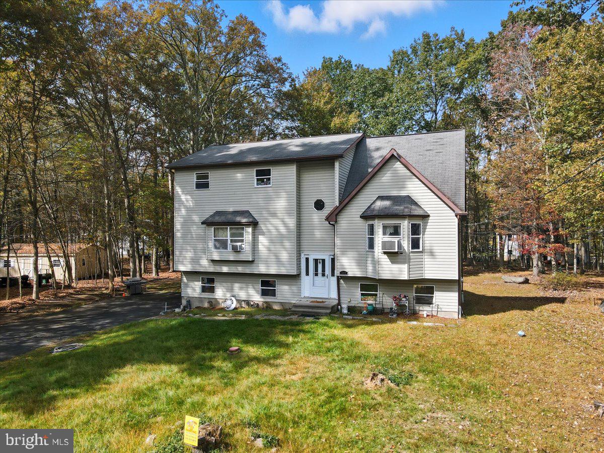 For sale: 209 Julia Terrace, located in the heart of the Pocono Mountains in the gated Penn Estates community of East Stroudsburg, PA. This spacious home features 3 bedrooms and 2 full bathrooms, including a luxurious upstairs master suite with a jacuzzi tub, full bathroom, and two oversized walk-in closets that could easily be converted into additional bedrooms, a home office, or a nursery. The main level offers two large bedrooms, a bright living room, a functional kitchen, and another full bathroom. The basement is nearly finished and includes a third bathroom with plumbing already completed—just needs final finishing. Additional highlights include a two-car garage, a driveway that fits up to five vehicles, and large front and back yards perfect for outdoor living and entertaining. Located in the desirable Penn Estates community, residents enjoy 24/7 gated security and access to amenities such as a swimming pool, gym, tennis and basketball courts, playgrounds, and more. Whether you're searching for a full-time home, vacation property, or investment opportunity, this home offers space, comfort, and great potential—just minutes from Route 80, shopping, schools, and all the attractions the Pocono Mountains have to offer.
