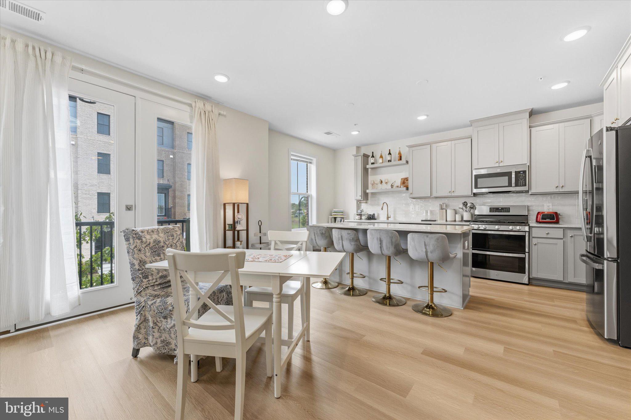 ****THIS IS NOT A STACKED UNIT!**** 4 FLOORS TOTAL WITH ROOFTOP! 
Welcome to this stunning townhome-style condominium—the Collier W/TR by Van Metre Homes—nestled in the highly sought-after Broadlands community. Offering 2,336 finished square feet across four thoughtfully designed levels, this nearly new home (just 3 years old) delivers the perfect blend of modern luxury, comfort, and low-maintenance living.
Step inside to discover 9-foot ceilings and a versatile entry-level recreation room, ideal for a home office, gym, or additional living space. This level also features a convenient half bath and direct access to the private, rear-load one-car garage.
The main living level is designed for both everyday living and entertaining, showcasing a beautifully appointed kitchen with upgraded cabinetry, quartz countertops, stainless steel appliances, and a large center island. The open-concept layout flows seamlessly into the dining and living areas, creating a bright and inviting atmosphere.
Retreat to the luxurious primary suite, complete with walk-in closets and a spa-like en-suite bath featuring dual vanities and an oversized frameless glass shower. Two additional bedrooms and a well-appointed full bath provide plenty of space for family or guests.
At the top, a true showstopper awaits—your private rooftop terrace. Whether hosting friends or enjoying a quiet evening, this space offers the perfect setting with expansive, scenic views.
Built with modern energy efficiency standards, this home offers peace of mind and cost savings. Beyond your front door, Broadlands delivers an exceptional lifestyle with access to multiple pools, a clubhouse, fitness center, tennis courts, scenic trails, and abundant green space.
Ideally located just minutes from shopping, dining, commuter routes, and Ashburn’s Silver Line Metro station, this home offers unmatched convenience in one of the area’s most desirable communities.
This is elevated, easy living at its finest—don’t miss it.