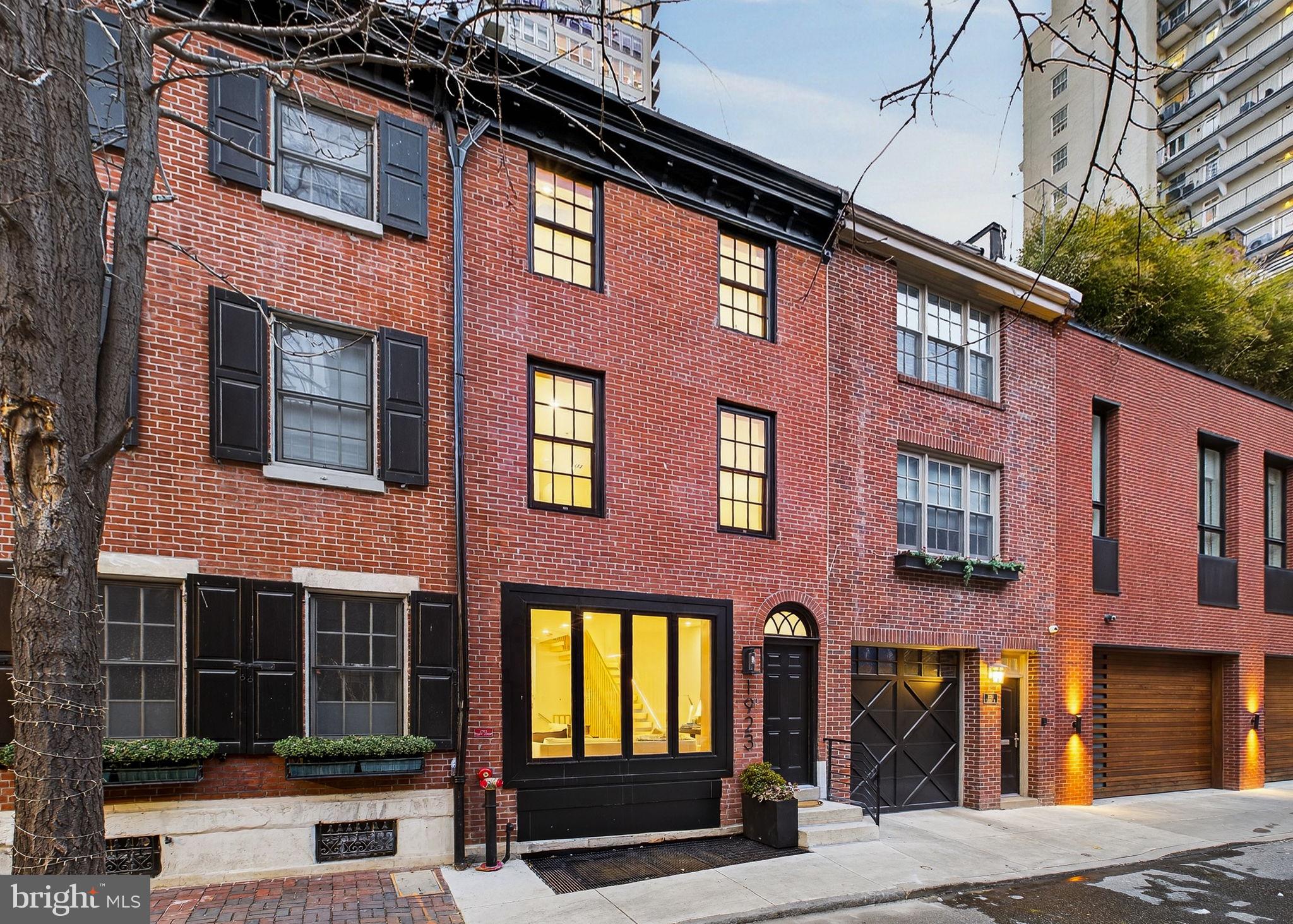 One block from Rittenhouse Square, 1923 Manning Street is a fully restored and structurally reimagined townhome offering over 4,000 square feet of elevator-served living behind a preserved 1860s façade.

Arranged across five levels, this 4-bedroom, 4 full and 2 half bath residence combines historic character with a discreet vertical addition and modern infrastructure rarely found this close to the Square.

A sculptural floating staircase anchors the interior, complemented by engineered Brazilian Oak wide-plank flooring and expansive natural light. The main level flows seamlessly from living and dining spaces into a chef-caliber kitchen appointed with Porcelanosa cabinetry, Wolf and Sub-Zero appliances, Bosch integration, and genuine soapstone countertops. Private outdoor space extends entertaining beyond the kitchen.

The entire third level is devoted to a vaulted primary suite with skylights, fireplace, walk-in closet, and spa-level bath featuring radiant heated floors. Additional bedrooms are thoughtfully positioned for privacy and flexibility. The finished lower level provides additional living space with a full bath — ideal for media, fitness, office, or guests.

At the top, sliding glass doors open to a roof terrace with sweeping skyline views and integrated outdoor kitchen — a rare indoor-outdoor experience within one block of the Square.

Supported by 3-zone Carrier HVAC, commercial-grade 2-hour exterior and elevator shaft construction, engineered shear wall structure, and tankless hot water with recirculation, the home offers structural depth beyond typical renovations in this micro-location.

Two nearby garage parking spaces are available (rented and prepaid for one year with an acceptable offer).

Situated on a quiet Manning Street block steps from Walnut Street and the Square itself, this residence offers rare scale, elevator integration, and architectural integrity in one of Philadelphia’s most sought-after neighborhoods.  10-year tax abatement approved.