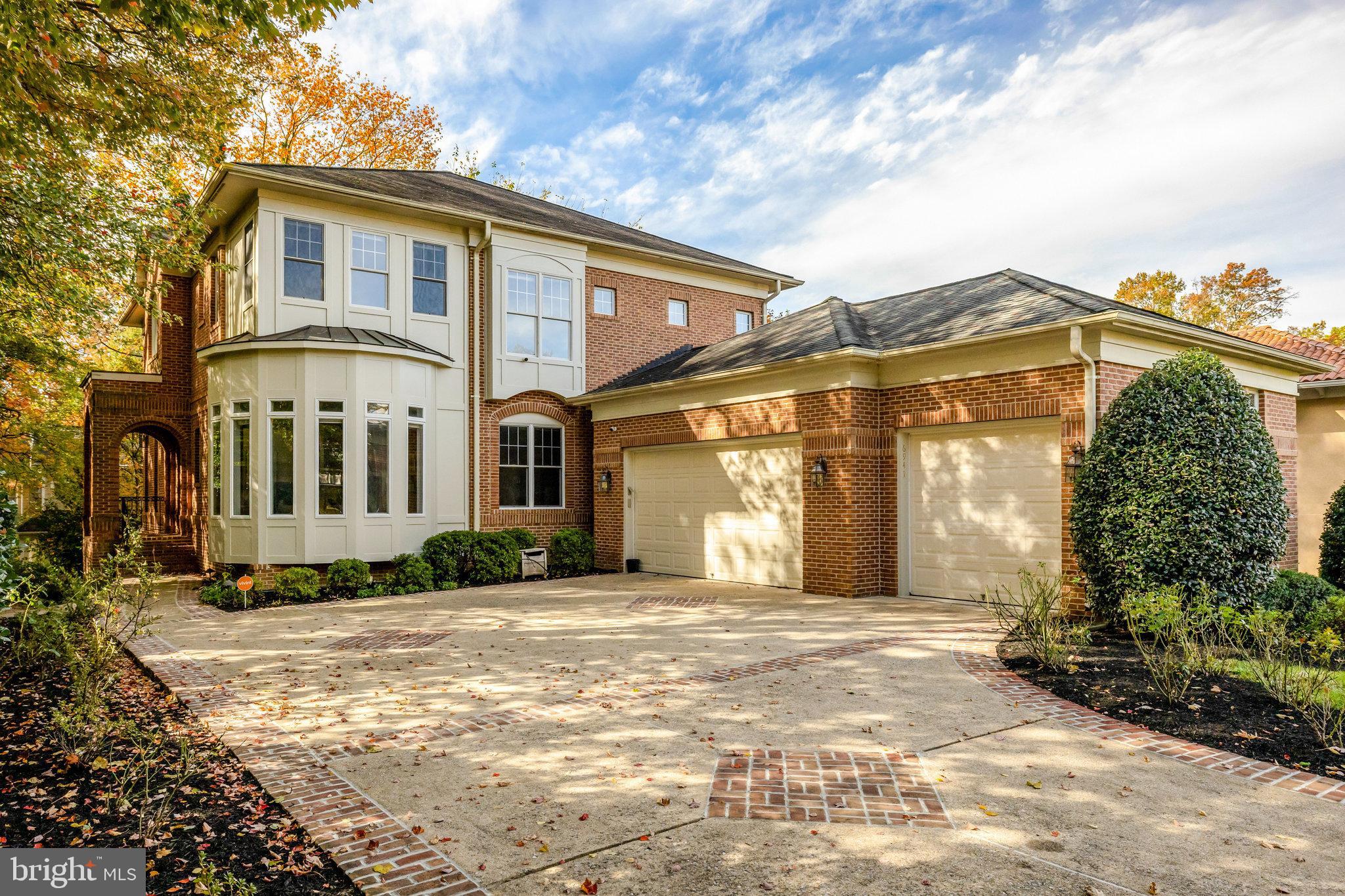 Open Sunday 1-3pm! Every detail of this beautifully crafted all-brick colonial has been thoughtfully designed to create a seamless flow and a warm yet sophisticated ambiance. Nearly 6,000 total Sq Ft 

A dramatic two-story foyer welcomes you with soaring ceilings and a view through the sun-drenched living room, where a wall of floor-to-ceiling windows bathes the space in natural light. Elegant custom moldings, tray ceilings, and rich millwork add timeless character throughout.

The expansive family room with a marble-surround fireplace opens to a phenomenal rear deck — perfect for effortless indoor-outdoor entertaining. The adjoining chef’s kitchen is impeccably appointed with dual wall ovens, an oversized pantry, and convenient access to the mudroom and three-car garage. An embassy-sized dining room makes a striking statement for formal gatherings, while the light-filled living room provides the perfect balance of comfort and sophistication.

Beyond double doors, the gracious primary suite serves as a private retreat, featuring a spacious sitting area with fireplace, a spa-inspired bath, and abundant closet space. Three additional bedrooms on the upper level offer ensuite or shared Jack-and-Jill baths and generous walk-in closets.

The walk-out lower level is designed for recreation and relaxation, complete with a nanny or guest suite, full bath, two walk-in closets, a wet bar, and a theater room — ideal for entertaining.

Perfectly situated on a quiet, tree-lined street just a short walk to downtown McLean, the McLean Metro, and minutes from Tysons Corner’s premier shopping and dining. Convenient access to both Reagan National and Dulles International Airports makes this property a true commuter’s dream.