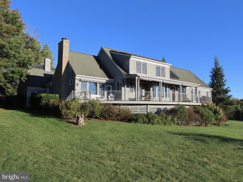 32 ACRES of PRIVACY & TRULY PANORAMIC MOUNTAIN VIEWS.  Offered Comfortably Furnished (at your discretion) for easy immediate use.  3,400 sq ft cape with in-ground pool complex,  flowering landscaping and roof top solar.  This home will please the most discerning.  Several rooms for entertaining and study. Excellent Kitchen with granite counters and Family Room with wood burning fireplace and opposing television nook.  Primary Suite on main with heated bathroom floor plus private deck with hot tub and outdoor shower.   Two comfortable upper bedrooms with shared hall bath plus walk in attic for potential expansion.    Large windows capture mountain views from every room.   Home is privately situated on a knoll, well off the road.  7 acre hay field and 23 acre forest with stream and trail in back.   Fox Hunt Country.