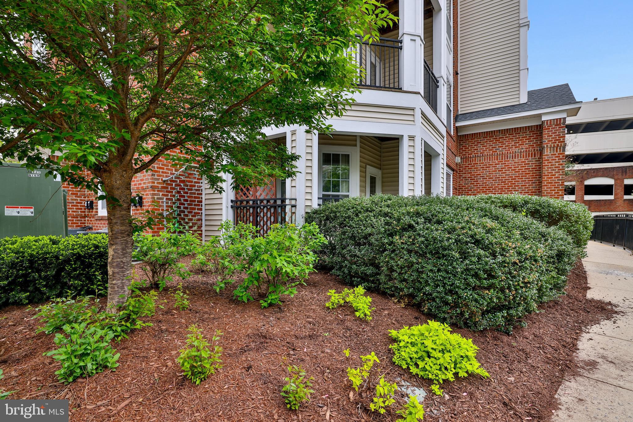 Welcome to The Bryson!  Rarely available Ground level (no steps) corner unit flooded with sunlight with private patio with a pleasant view!   Two reserved parking spaces – one just 20 steps to the front door – are not common in the Bryson. 

Conveniently located just steps to Woodland Park Crossing: walk to Harris Teeter, shops, restaurants and more, with numerous walking, jogging and biking paths nearby.  Excellent commuter location within walking distance to the Silver Line Metro, and great proximity to Rt. 286, Dulles Toll Road, Rt. 28 and 10 minutes to Dulles International Airport.  Less than 10 minutes to Reston Town Center with over 50 boutique shops, 35 restaurants & movie theatre, plus numerous events held throughout the year.  

This corner unit features 9-foot ceilings, windows on both sides that flood the unit with natural sunlight. Step into the warm family room with cozy gas fireplace and ceiling fan, kitchen with stainless steel appliances, raised-panel cabinetry and granite counters plus a separate dining area surrounded by windows.  A large laundry area plus large walk-in storage closet offers the perfect place for those seasonal items.   The primary bedroom offers walk-in closet and en-suite primary bath featuring 12” ceramic tile flooring, granite vanity and tub/shower with tile surround.

The Bryson offers a well-managed property with an on-site concierge, a beautiful clubhouse featuring a lounge area with fireplace, club room with billiards and game area, workout facility, business center, outdoor grilling stations & gorgeous pool.