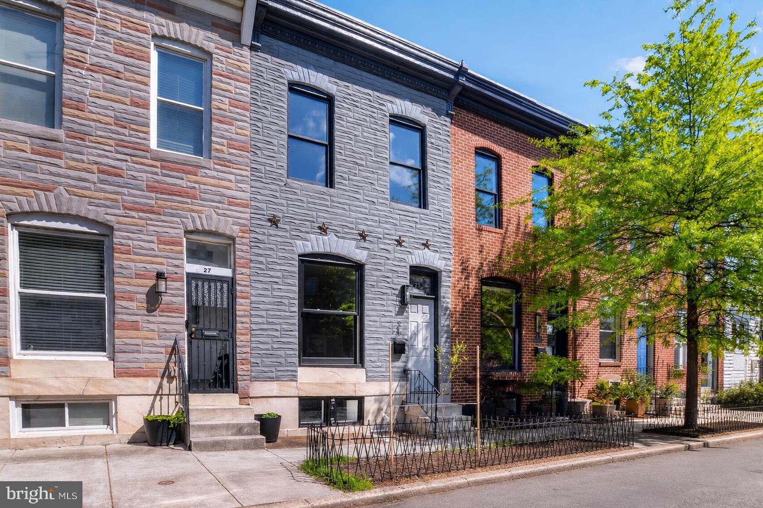 Welcome to 25 N Ellwood Ave, a charming rowhouse that blends historic character with modern updates throughout. Renovated in 2022 and recently painted from top to bottom, this stylish home is ready for you to call it your own. The classic marble stoop, tile vestibule, and beautiful stained-glass transom window set a characterful tone in the entry hall. The main floor offers flexible living and dining spaces, while the kitchen has ample storage, workspace, and stainless steel appliances. Keep your outdoor gear tucked away in the convenient mudroom leading to a private rear patio that can double as secure parking if needed. A skylight brightens the upstairs featuring a spacious primary suite with ensuite bath, plus a large second bedroom and full hall bath. The lower level bedroom adds versatility with a convenient full bath. Alternatively, the space is ideal for an office, media room or home gym. Fantastic location near Patterson Park, Canton Crossing, and easy access to Downtown and I-895. Steps from Vivian's Restaurant, Patterson Public House, Matthew's Pizza and Monument City Brewing. Bonus: the remaining CHAP tax credit offers potential savings to a new buyer. Don't miss this inviting home!