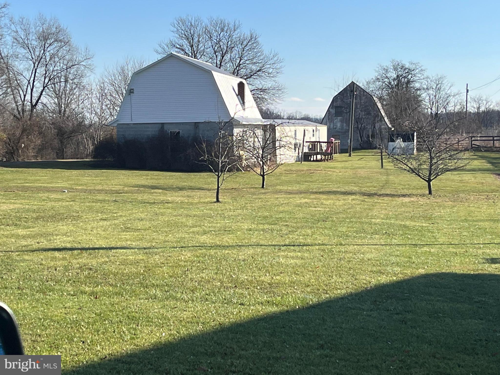 Unique income-producing property situated on approximately 9.4 acres featuring multiple rental streams and versatile use potential. Property includes a manufactured home currently leased for $1,250/month, detached garage generating $950/month, and barn/storage space with projected rental income of approximately $975/month. Gross potential income approaches $40,000 annually. This property is convenient to the neighboring airport. 

Ideal opportunity for investors, contractors, hobby farm enthusiasts, or buyers seeking a live/work setup with supplemental income. Ample parking and flexible space for storage, equipment, workshop use, or recreational purposes.

Excellent potential for continued cash flow, future appreciation, and expanded use options. Rare opportunity to own a multi-use property with established income in a convenient location near Martinsburg and major commuter routes.

Buyer to verify zoning and intended use.

Approximate Drive Times
From I-81 Exit 13 / Route 9 interchange:  8 minutes
From downtown Martinsburg:  10 minutes
From Charles Town via Route 9:  25 minutes