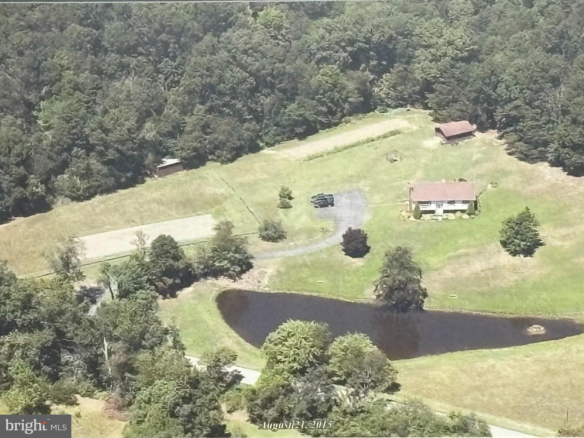 Escape to the peace and freedom of country living with this spacious 4-bedroom, 2-bath home situated on 6.18 unrestricted acres featuring a beautiful, stocked pond and endless possibilities. Whether you're dreaming of a hobby farm, recreational retreat, or simply more room to spread out, this property offers the flexibility to make it your own.

Inside, you'll find a functional floor plan featuring a spacious kitchen and dining room combination with abundant cabinetry, generous counter space, and plenty of room for preparing meals and gathering with family and friends. Just off the dining area, step onto the deck—the perfect place to enjoy your morning coffee, entertain guests, or relax while overlooking the peaceful countryside.

The home offers two separate family rooms, providing flexible living spaces for entertaining, relaxing, a home office, or playroom. An oversized laundry room and dedicated mud room add convenience and extra storage for everyday living.

Stay comfortable year-round with multiple heating options, including propane heat, a pellet stove, fireplace, electric baseboard heat, and a mini-split system, allowing you to choose the heating source that best fits your needs. A whole-house central vacuum system adds everyday convenience.

Outside, you'll appreciate the detached garage with electric service and generator hookup that will supply your whole house if the power goes out, along with a barn, carport, and ample room for equipment, recreational vehicles, or workshop space. Spend your evenings fishing in the stocked pond, watching abundant wildlife, or simply enjoying the serenity of your own private retreat.  

With no restrictions, the opportunities are endless. Bring your horses, chickens, goats, or other animals, establish gardens, host family gatherings and outdoor events, or simply enjoy the freedom and privacy that unrestricted acreage provides. Whether you're looking for a full-time residence, a weekend getaway, or your own private homestead, this property offers the space, versatility, and country lifestyle you've been searching for. Properties like this don't come along every day, don't miss your chance to own this beautiful slice of Almost Heaven - West Virginia

Schedule your private showing today and discover everything this exceptional property has to offer!