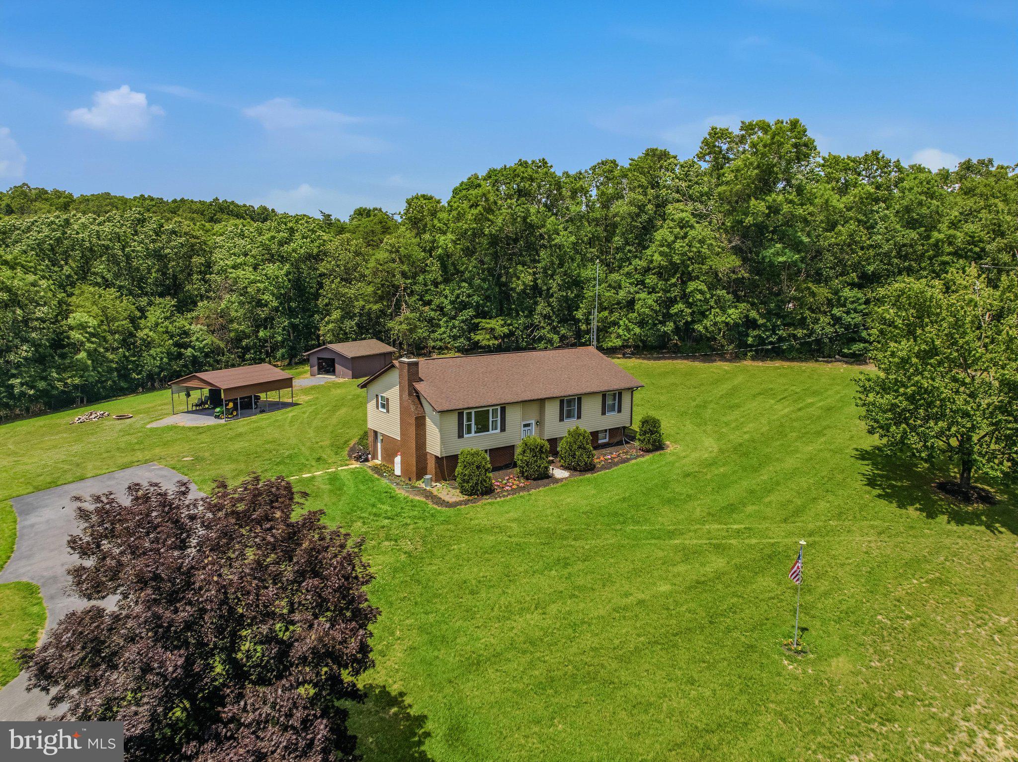 Escape to the peace and freedom of country living with this spacious 4-bedroom, 2-bath home situated on 6.18 unrestricted acres featuring a beautiful, stocked pond and endless possibilities. Whether you're dreaming of a hobby farm, recreational retreat, or simply more room to spread out, this property offers the flexibility to make it your own.

Inside, you'll find a functional floor plan featuring a spacious kitchen and dining room combination with abundant cabinetry, generous counter space, and plenty of room for preparing meals and gathering with family and friends. Just off the dining area, step onto the deck—the perfect place to enjoy your morning coffee, entertain guests, or relax while overlooking the peaceful countryside.

The home offers two separate family rooms, providing flexible living spaces for entertaining, relaxing, a home office, or playroom. An oversized laundry room and dedicated mud room add convenience and extra storage for everyday living.

Stay comfortable year-round with multiple heating options, including propane heat, a pellet stove, fireplace, electric baseboard heat, and a mini-split system, allowing you to choose the heating source that best fits your needs. A whole-house central vacuum system adds everyday convenience.

Outside, you'll appreciate the detached 20'x24' garage with electric service and generator hookup that will supply your whole house if the power goes out, along with a 17'x25' shed, 22'x26' carport, and ample room for equipment, recreational vehicles, or workshop space. Spend your evenings fishing in the stocked pond, watching abundant wildlife, or simply enjoying the serenity of your own private retreat.  

With no restrictions, the opportunities are endless. Bring your horses, chickens, goats, or other animals, establish gardens, host family gatherings and outdoor events, or simply enjoy the freedom and privacy that unrestricted acreage provides. Whether you're looking for a full-time residence, a weekend getaway, or your own private homestead, this property offers the space, versatility, and country lifestyle you've been searching for. Properties like this don't come along every day, don't miss your chance to own this beautiful slice of Almost Heaven - West Virginia

Schedule your private showing today and discover everything this exceptional property has to offer! PROFESSIONAL PHOTOS COMING SOON