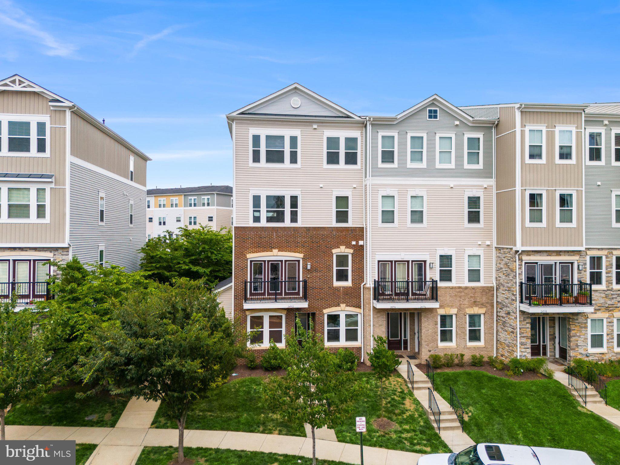 Filled with natural light and thoughtfully designed across four finished levels, this beautifully maintained end-unit townhome in sought-after Stone Ridge offers the perfect balance of style, comfort, and convenience.

The entry level welcomes you with a versatile recreation room featuring hardwood floors - an ideal space for a media room, home office, playroom, fitness area, or cozy retreat. A mudroom with additional storage separates the living space from the rear-entry one-car garage, while the private driveway and abundant neighborhood parking provide added convenience for both residents and guests.

Ascend to the main living level, where hardwood floors and an open-concept layout create an inviting atmosphere. The kitchen serves as the heart of the home, featuring granite countertops, a breakfast bar with seating for four, stainless steel appliances, gas cooking, and a pantry for additional storage. The adjoining great room offers a comfortable gathering space and provides direct access to the private balcony - perfect for morning coffee, dining al fresco, or simply unwinding at the end of the day. A conveniently located powder room completes this level.

The third level is dedicated to the spacious primary suite, offering a peaceful retreat complete with plush carpeting, a walk-in closet, and a private en suite bath featuring dual vanities and a walk-in shower. The laundry closet is also conveniently located on this level.

The fourth level hosts two additional bedrooms, each featuring carpeting, ceiling fans, and generous closet space. A full hall bath services this level, creating comfortable accommodations for family members and guests alike, while also offering flexibility for additional home office or hobby space. The utility/mechanical room is also conveniently located on this level.

Life in Stone Ridge is centered around connection, recreation, and convenience. Residents enjoy an impressive collection of amenities including multiple pools, basketball courts, sports fields, tot lots, and a clubhouse with fitness center. The community also offers access to Byrne Ridge Park, a 26-acre park featuring an ADA-accessible multipurpose trail, batting cages, sports fields, picnic areas, and open green space to explore and enjoy.

Ideally located within walking distance of the Gum Spring Library and just minutes from the Dulles South Recreation & Community Center, grocery stores, restaurants, cafés, and everyday conveniences, this home also offers exceptional commuter access. The nearby Stone Ridge Park & Ride provides convenient transit options to Metro stations, Rosslyn, Crystal City, and Washington, D.C., while Routes 50, 28, the Dulles Greenway, and Dulles International Airport are all easily accessible.

Whether you're enjoying coffee on the balcony, gathering with friends in the great room, or taking advantage of the countless amenities just beyond your front door, this is more than a home - t's a lifestyle designed to be enjoyed every day.