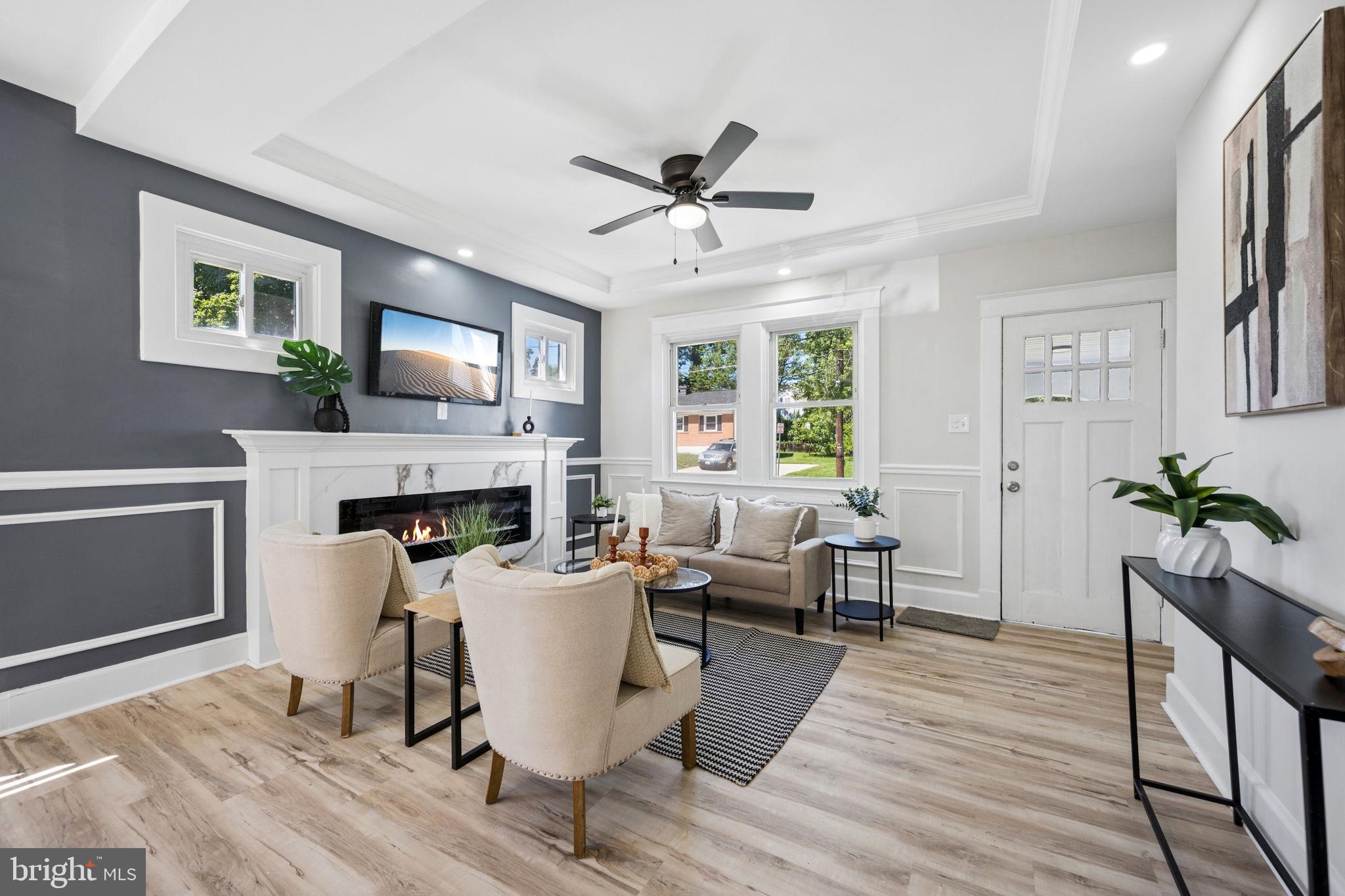 Welcome to 517 Valcour Rd, a beautifully updated cape cod that blends timeless charm and contemporary comfort. From the moment you arrive, the home's distinctive stepped parapet roofline and crisp white stucco exterior set it apart, while a stone path winds through a freshly landscaped lawn to a welcoming front porch. Step inside to an inviting living room featuring a tray ceiling with crown molding, a striking  accent wall, and a sleek linear electric fireplace — the perfect focal point for relaxing evenings. Wide-plank luxury vinyl flooring flows throughout the main level, complemented by abundant natural light. The galley kitchen has been tastefully refreshed with crisp white cabinetry, granite countertops, subway tile backsplash, and stainless steel appliances, offering both style and function. A side door off the kitchen leads conveniently out to the back deck. Upstairs you'll find generously sized bedrooms offering plush carpet, ceiling fans, and ample closet space. The updated bathroom impresses with a marble-tiled tub surround and modern LED-lit vanity mirror. Outside, the fully fenced backyard provides privacy and plenty of room to play, complete with a brand-new wood deck and staircase off the rear of the home — a great spot for morning coffee or weekend get-togethers. The basement offers tons of storage as well as a finished bonus room, perfect for a guest bedroom, office, or rec room. This move-in-ready home offers the perfect combination of. Don't miss your chance to make 517 Valcour Rd yours!