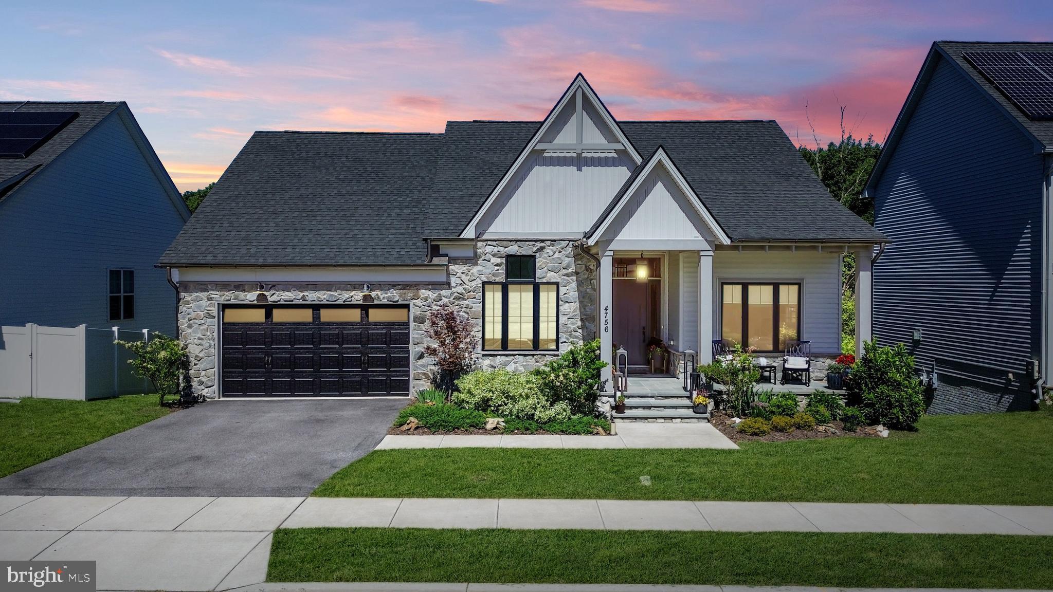 Wow! This fantastic, better-than-new Wormald-built home is situated on a great lot in the desirable Landsdale community. This beautiful home looks and shows like a model! You'll be welcomed by the great curb appeal of the professionally landscaped yard, the stone front exterior, and the cozy front porch—perfect for enjoying your morning coffee! Inside, the thoughtfully designed floor plan is loaded with premium upgrades, including wood-beam accents, upgraded modern lighting, luxury flooring, and motorized blinds. On the main level, you’ll find a convenient, dedicated home office with an elegant, glass-paned sliding barn door and a large double closet--allowing this room to function as an office or as a potential fifth bedroom. The light-filled Great Room, with a gas fireplace and custom built-in cabinetry, is a true gem. Whether you're looking to unwind after a long day or spend quality time with loved ones, this room provides the perfect setting for relaxation. This space flows seamlessly into the gourmet chef's kitchen, featuring a massive island with breakfast bar seating, upgraded custom cabinetry, quartz countertops, a custom tile backsplash, stainless steel appliances, and a walk-in pantry.  Bring the outdoors in with stunning multi-panel sliding glass doors that seamlessly connect the kitchen to a spacious screened-in porch for the ultimate indoor-outdoor lifestyle. Step out further from the screened-in porch to the large, low-maintenance deck overlooking serene, wooded views—an outdoor oasis built for relaxation. For ease of entertaining, guests can gather on the deck or walk down the connected stairs to the covered patio below or gather around the stone firepit. The main level also features a luxurious Owner’s Suite bathed in natural light, complete with an elegant tray ceiling, a massive walk-in closet, and a spa-like en suite bath with a dual vanity, a custom-tile shower with dual showerheads and a built-in bench, and a separate water closet. A second main-level bedroom with a private en suite bath serves as the perfect guest retreat. A convenient half bath, a laundry room, and a dedicated Welcome Center with cubbies — off the two-car garage — complete this level. The light-filled, finished walk-out lower level is built for entertaining. It features a massive recreation area, a wet bar with a refrigerator and dishwasher, two additional bedrooms, and a full bathroom. Step outside to the spacious patio and built-in fire pit, surrounded by a private backyard that backs to mature trees. Perfectly situated for commuters with easy access to I-70 and I-270, this home is just a short walk to Landsdale’s incredible resort-style amenities. Enjoy the community pool, clubhouse, amphitheater, sports courts, and playgrounds—including one with a zipline! With active clubs and HOA-sponsored events, this move-in-ready gem offers both a luxury home and an unmatched lifestyle.