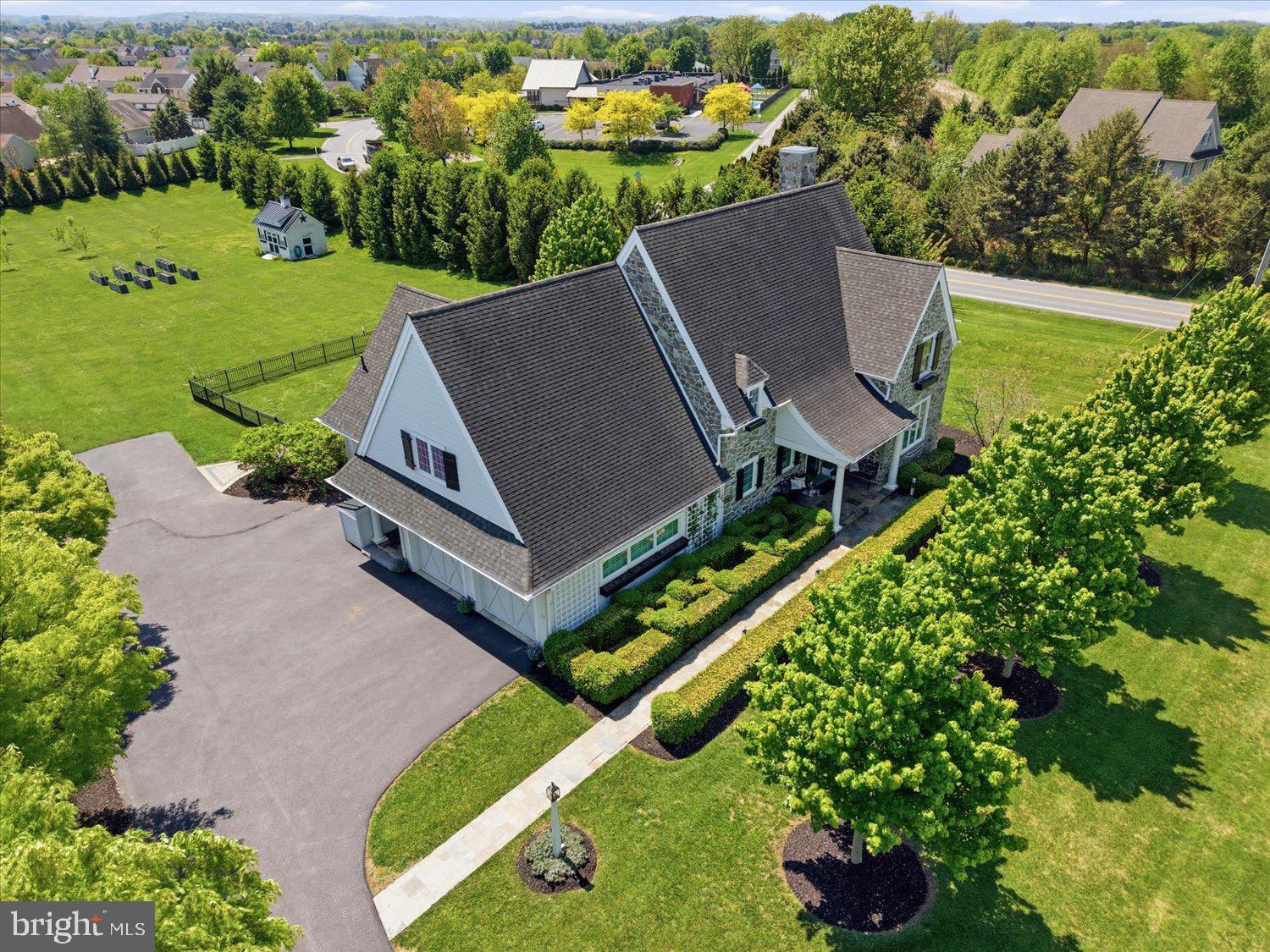 The ultimate trophy estate with an absolute premier location in Manheim Township, Reidenbaugh Elementary! Ideally set behind a long tree-lined driveway on 3 flat acres moments from Bent Creek Country Club. Rarely does a property of this caliber become available—NO HOA, and complete privacy. The front stone facade exterior with covered columned front porch, quarried stone walkway, manicured boxwood hedges, carriage-style garage doors, and black shutters make a striking first impression. The grounds are expansive, with lush lawns ready for a pool, pickleball/sports court, or other amenities. The property offers potential for a second homesite, creating a rare opportunity to build, invest, or preserve your private estate. Inside, this Costello custom-built home spans 3,611 sq ft with attention to detail in every corner. The first floor primary suite boasts a spa-like tile walk-in shower with custom glass enclosure, towel warmer, clawfoot soaking tub, and his and hers closets. Vintage wide plank pine flooring runs throughout the entire main level. Dramatic coffered ceilings and an open-concept layout flow from the living room with fireplace to the dining room and the magazine-quality hand-crafted shaker kitchen. The kitchen includes a center island, quartz countertops, 36-inch Café Professional dual-fuel stove, commercial-grade appliances, walk-in pantry, abundant storage, and an instant hot and touchless water faucet. Plantation shutters and a stunning Ethan Allen chandelier with lift complete the space. The sunroom with floor-to-ceiling windows, transoms, and motorized solar shades overlooks the grounds and opens to the fenced stone patio with hot tub and multiple seating areas. Additional first-floor features include laundry with farmhouse sink, half bath with wainscoting, and covered side porch. Upstairs are three additional bedrooms and a bonus room ideal for an office, playroom, or fifth bedroom. The Jack-and-Jill bath includes separate vanities and toilets on each side with a shared tub and shower in the center. The 1,770 sq ft Superior wall basement with roughed-in plumbing and two egress windows could bring the total finished space to 5,381 sqft. Other features include a 3-zone GEOTHERMAL HVAC system with a 900-foot well, a second 300-foot irrigation well, Glick custom garden shed with electrical and water service, eight raised organic self-watering garden beds, photo-controlled exterior lighting, oversized motor court, 30-amp outdoor plug, whole-house generator, 3-car side-load garage, public water and sewer, and more. A rare and exceptional offering in a premier location!