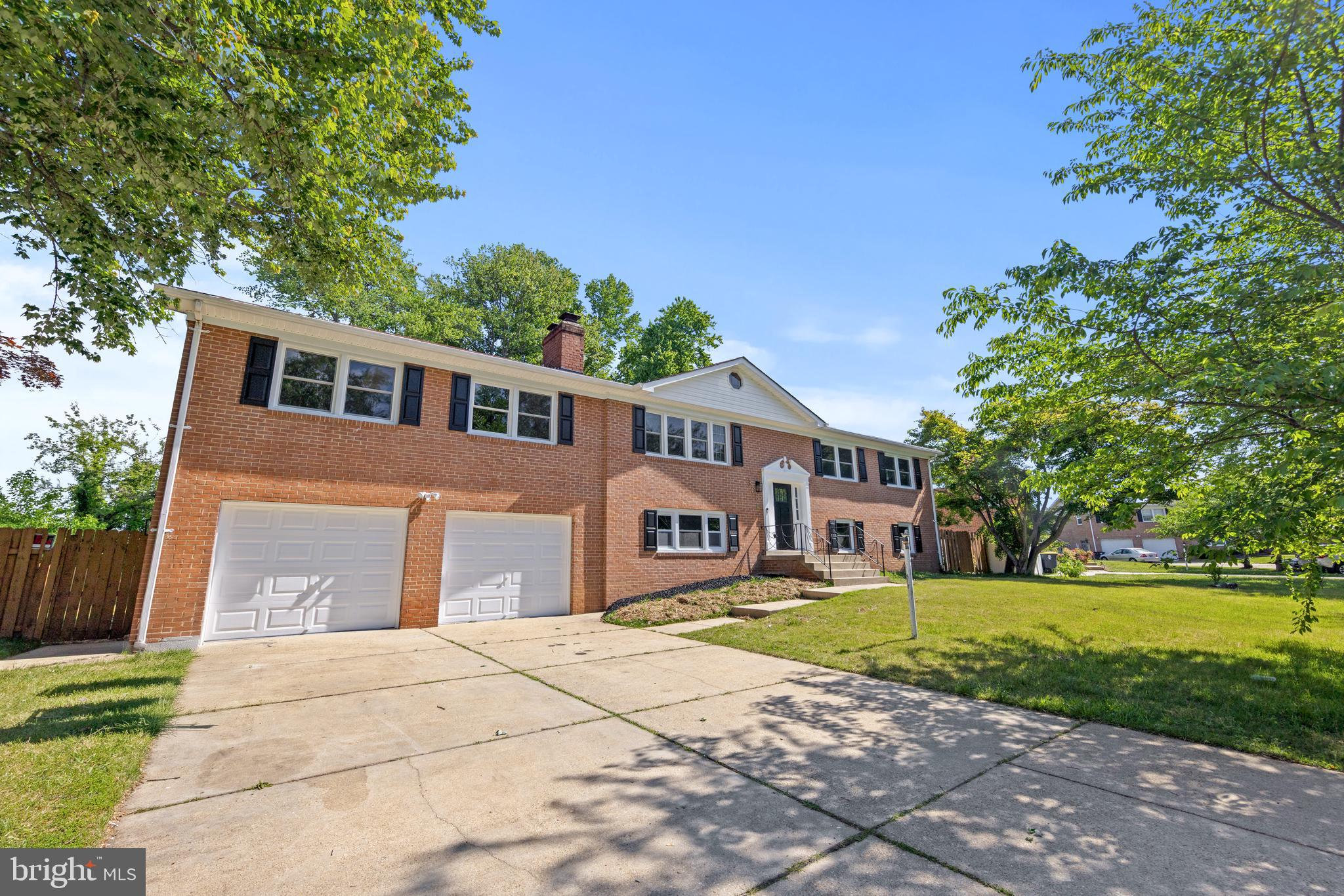 Sophisticated and fully renovated, this split-foyer features refined finishes and a seamless layout. The main level includes a sunlit living area and a kitchen with gray cabinetry and stainless steel appliances. Three bedrooms and two full baths are located on the upper floor. The finished lower level adds a fourth bedroom, third full bath, and a family room with a brick fireplace. The private backyard includes a large in-ground pool. Move-in ready.