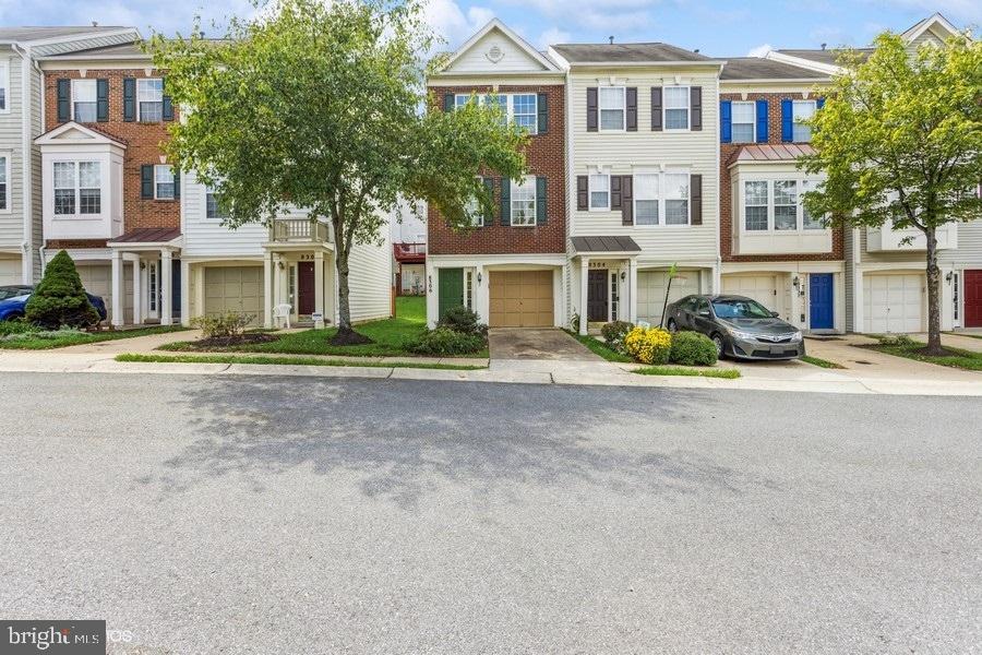Beautifully updated 3-level townhome located in the Russett community of Laurel, Maryland. This stunning one car garage end unit has a new roof, heating and cooling system, luxury vinyl plank flooring and carpet. All the bathrooms and the kitchen have been updated with modern finishes. The entire interior has been freshly painted with a neutral light gray. Enjoy two oversized bedrooms and two full bathrooms on the upper level. The main level is complete with spacious kitchen, half bathroom, fireplace and open dining room that flows into the living room. Walk-out the sliding glass door to a rear deck overlooking the common grass area. The lower level offers a separate family room, play area or office with a door leading to the rear yard. The community amenities include pools, tennis, basketball and volleyball courts, tot lots and community trails. This ultra convenient location is right around the corner from 295, 198 and I-95 and a short drive to Ft Meade, NSA, NASA Goddard, BWI, Arundel Mills, FDA in Laurel, Annapolis Junction.