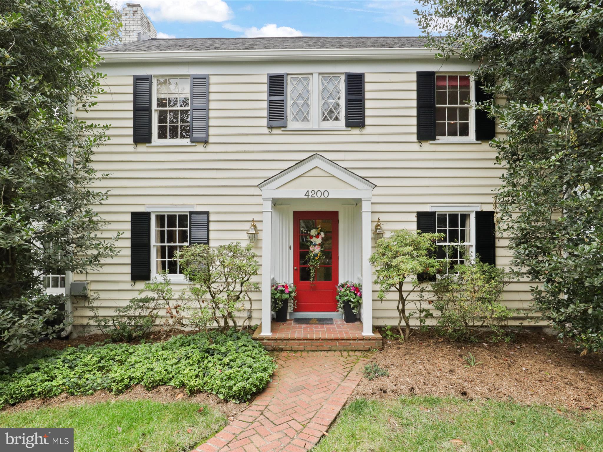 This expanded 1939 colonial combines timeless charm with modern living spaces, making it a perfect match for today’s homeowners.  Enter the home through a covered porch into a spacious foyer that leads to a formal living room with a fireplace and a large dining room, ideal for hosting guests. The updated kitchen includes an island and opens into a vast family room with cathedral ceilings, wooden beams, skylights and a second fireplace. From here, step onto the deck that overlooks a private, beautifully landscaped huge backyard.

The main level also features a master suite with custom shelving and  connects to a serene screened porch—perfect for a relaxing mornings to read the paper. Tucked away is a private, glass-enclosed den, providing an intimate space for work or an afternoon nap.

The second level boasts three generously sized bedrooms with oak hardwood floors and two ceramic-tiled baths. The standout feature of the lower level is its suitability for multigenerational living. This level has its own sunroom leading to a private patio, an open-plan living space with an island kitchen, a large bedroom, an updated bathroom, and a separate laundry room. The two-car garage and ample storage make this home as practical as it is beautiful.

Located in the wonderful  Chevy Chase View neighborhood and sitting on a half acre lot,  this home offers proximity to Kensington's MARC station, Metro, NIH, downtown Bethesda, and the beltway.  4200 Dresden combining convenience with classic living.
