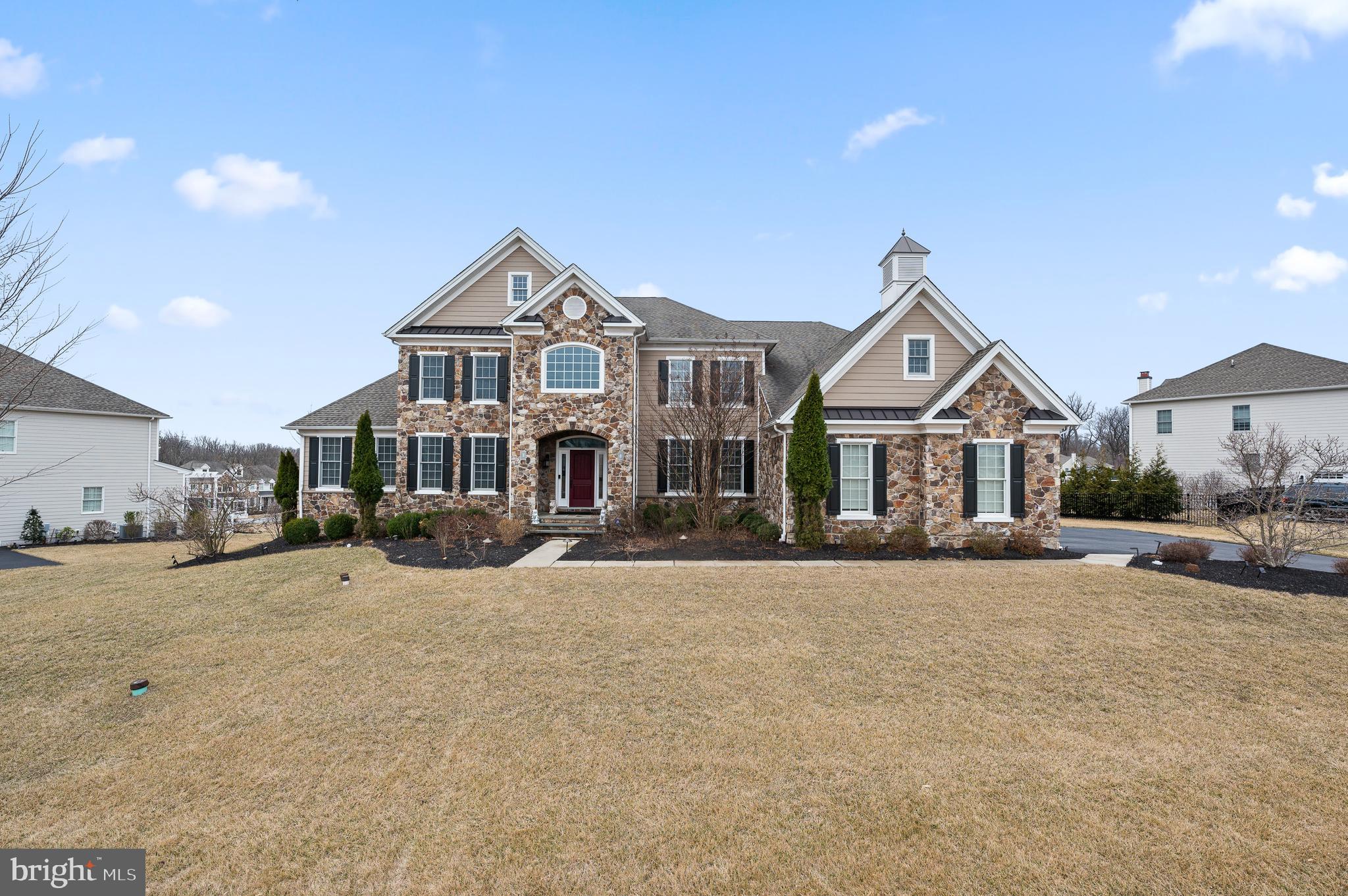 Welcome to 300 Greenbank Lane, a stunning home nestled in the sought-after community of Liseter in Newtown Square. The grand, stone-front elevation “Harding” model offers 5 bedrooms and 4.5 bathrooms, perfectly designed for luxury living and entertaining. As you enter through the airy 2-story foyer, you’ll be captivated by the double staircase and the open floor plan, creating elegance that surrounds you. The foyer is gracefully flanked by a formal living room and a sophisticated dining room with designer light fixtures, setting the tone for this magnificent home. The first floor features a convenient guest suite complete with a full bathroom, walk-in closet, and a cozy sitting area, ensuring privacy and comfort for your guests. (This room would also make a great playroom.) The heart of the home is the expanded, Palladium kitchen, a chef’s dream with its white cabinets, large island, quartz countertops, stainless steel appliances and walk-in pantry. Step outside to the expansive TREX maintenance-free deck, ideal for hosting summer BBQs and enjoying outdoor entertaining. Adjacent to the kitchen, the family room impresses with its dramatic 2-story ceiling and a cozy gas fireplace, creating a welcoming ambiance for family gatherings. A well-appointed office with a ceiling fan and bay window offers a perfect workspace. The first floor is further enhanced by a 3-car garage, a half bathroom, and a convenient laundry room. Upstairs, the second level boasts 4 bedrooms and 3 full bathrooms. The luxurious primary suite is a private retreat featuring a sitting area and a spacious bedroom. Enjoy the indulgence of two large walk-in closets and a lavish bathroom with dual vanities, a soaking tub, a stall shower, and a dedicated make-up area. There are three additional bedrooms, including two that share a Jack and Jill bathroom with a double vanity and a tub/shower combo, and a guest suite with an attached bathroom featuring a stall shower. The unfinished basement has walk-up stairs to the exterior, is plumbed for a bathroom, and the sellers paid a premium to have it dug out an extra foot, offering many possibilities. 300 Greenbank Lane is part of the “Bryn Mawr” collection in Liseter, which allows a fence or a playset. The Liseter community offers a wealth of amenities, including walking trails, a clubhouse, gym and swimming pool, tennis & pickleball courts, and community social events, ensuring a vibrant and active lifestyle. Conveniently located near shopping at Ellis Preserve with Whole Foods, dining, and next to top-rated Episcopal Academy and Marple Newtown Schools. Don’t miss the opportunity to make this stunning Harding model your forever home.