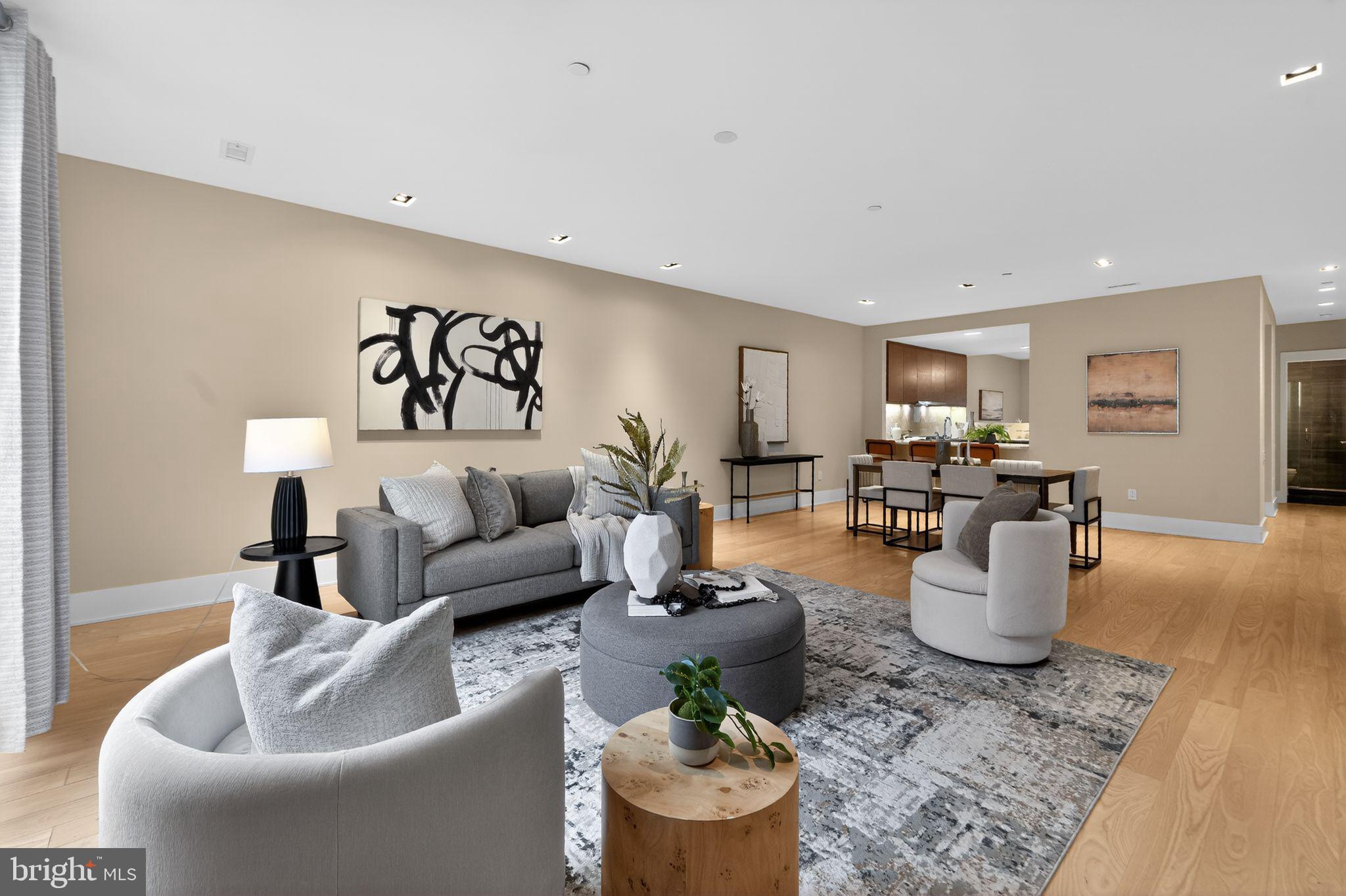 Tucked away on a quiet, tree-lined mews just steps from Rittenhouse Square, 2110 Sansom Street offers a rare opportunity to live in one of Philadelphia’s most architecturally celebrated modern residences. Designed by renowned architect Cecil Baker, this striking home within the coveted Van Pelt Mews blends bold contemporary design with the privacy and ease of townhouse living — all with no condo fee.

A private oversized garage provides secure, direct entry into the residence — an exceptional luxury in the heart of Rittenhouse.  With 136" (just over 11') ceilings in the garage, it leaves room for an optional lift to be added for a second car.  A second entrance (on the side at 107 VanPelt St) through the charming landscaped courtyard adds an additional layer of character and discretion, giving the home the feeling of a hidden retreat within the city.

Inside, the architecture truly takes center stage. Soaring ceilings, expansive windows, warm hardwood floors, and sleek, minimalist finishes create a space that is both sophisticated and inviting. Natural light floods the open-concept main living level, where a chef’s kitchen anchors the home—featuring custom wood cabinetry, with Sub Zero, Wolf and Asko paneled appliances and quartz countertops that seamlessly extend into the backsplash. The kitchen flows effortlessly into a generous dining area and an airy living room, creating an ideal setting for both intimate dinners and entertaining before stepping out to the neighborhood’s renowned restaurants.
The ground level offers a welcoming foyer, access to the oversized garage, and a private guest suite with a full bath—perfect for visitors—along with access to the outdoor patio and entry.
Upstairs, the primary suite serves as a tranquil retreat, complete with a spa-like en-suite bath and a spacious walk-in closet. An additional bedroom features its own en-suite bath, along with beautiful arched windows and doors leading to a Juliet balcony. A versatile bonus room, adjacent to a full hall bath, provides flexibility for a variety of uses—whether as a home office, gym, media lounge, or additional bedroom. Tax Abatement Expires 12-31-2028.

Outside your door, the very best of Rittenhouse awaits — morning coffee at neighborhood cafés, evening dinners at award-winning restaurants, boutique shopping, fitness studios, and the timeless beauty of Rittenhouse Square Park just moments away. It is also in the sought after Greenfield Elementary school catchment.

With a Walk Score of 99, this is effortless city living at its finest — where architecture, privacy, and neighborhood energy come together in one exceptional home.