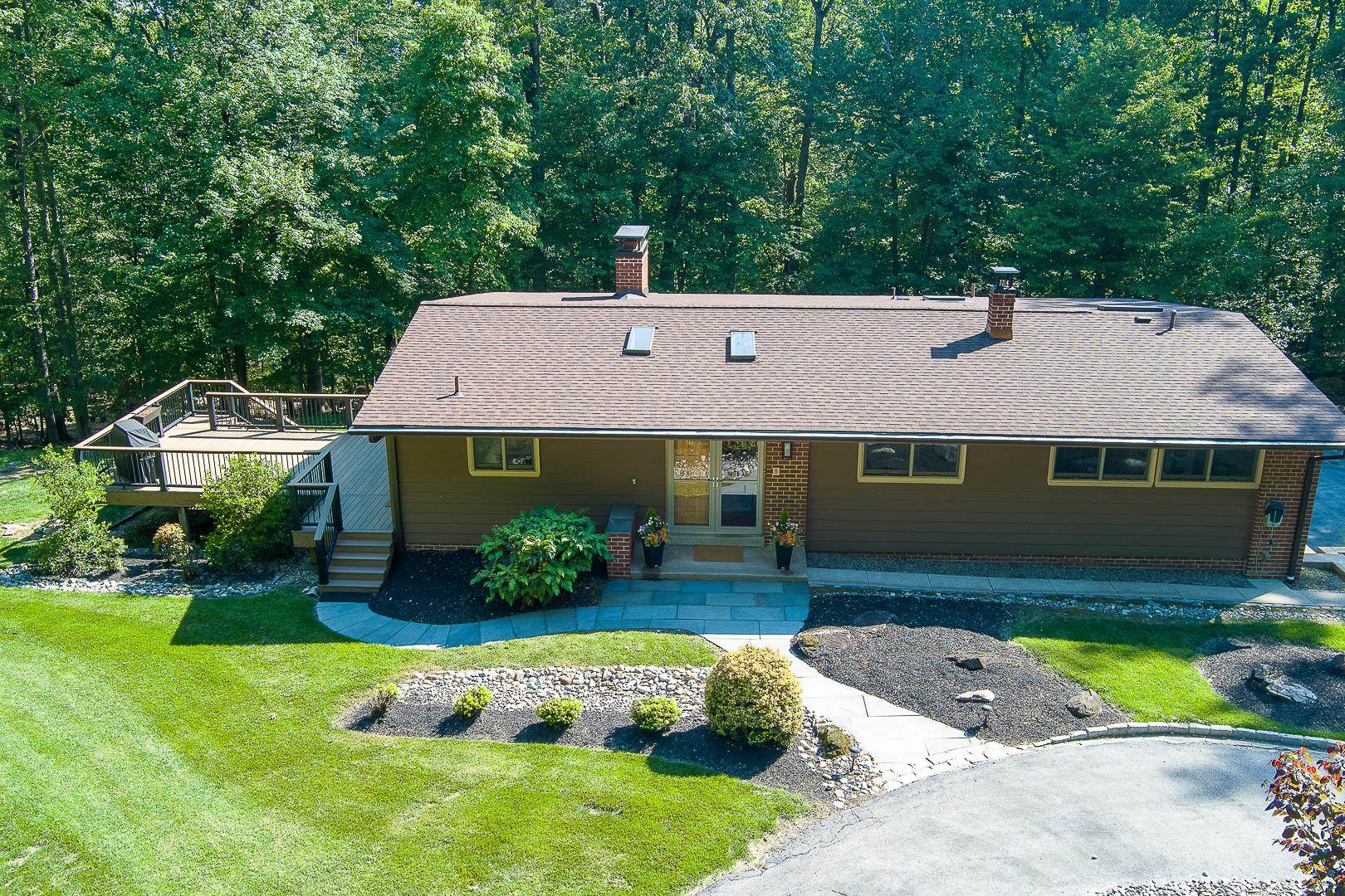 Nestled on a sprawling 3.9-acre lot, this exquisite contemporary residence offers a harmonious blend of luxury and comfort. Built in 1970, this home has been thoughtfully designed to embrace modern living while retaining its timeless charm. As you step inside, you are greeted by an inviting atmosphere that flows seamlessly throughout the spacious layout. The fully finished basement, complete with garage access and multiple entrances, provides endless possibilities for entertainment, relaxation, or even a private home office. The contemporary architectural style is complemented by large windows that invite natural light to dance across the interiors, enhancing the warm and welcoming ambiance. The outdoor space is a true sanctuary, offering ample room for outdoor activities, gardening, or simply enjoying the serene surroundings. Imagine hosting summer barbecues or evening stargazing under the expansive sky, all within the privacy of your own estate. This home is not just a residence; it's a lifestyle. The absence of a pool allows for a low-maintenance outdoor experience, giving you more time to explore the nearby amenities and attractions. Whether you prefer a leisurely stroll through nature or a quick drive to local shops and dining, this location provides the perfect balance of tranquility and convenience. With its unique blend of luxury features and inviting warmth, this property is a rare find. Experience the joy of living in a home that embodies both elegance and comfort, where every detail has been curated to enhance your everyday life. There have been many updates to the property, please reach out if you'd like to know more.  Don't miss the opportunity to make this exceptional residence your own.