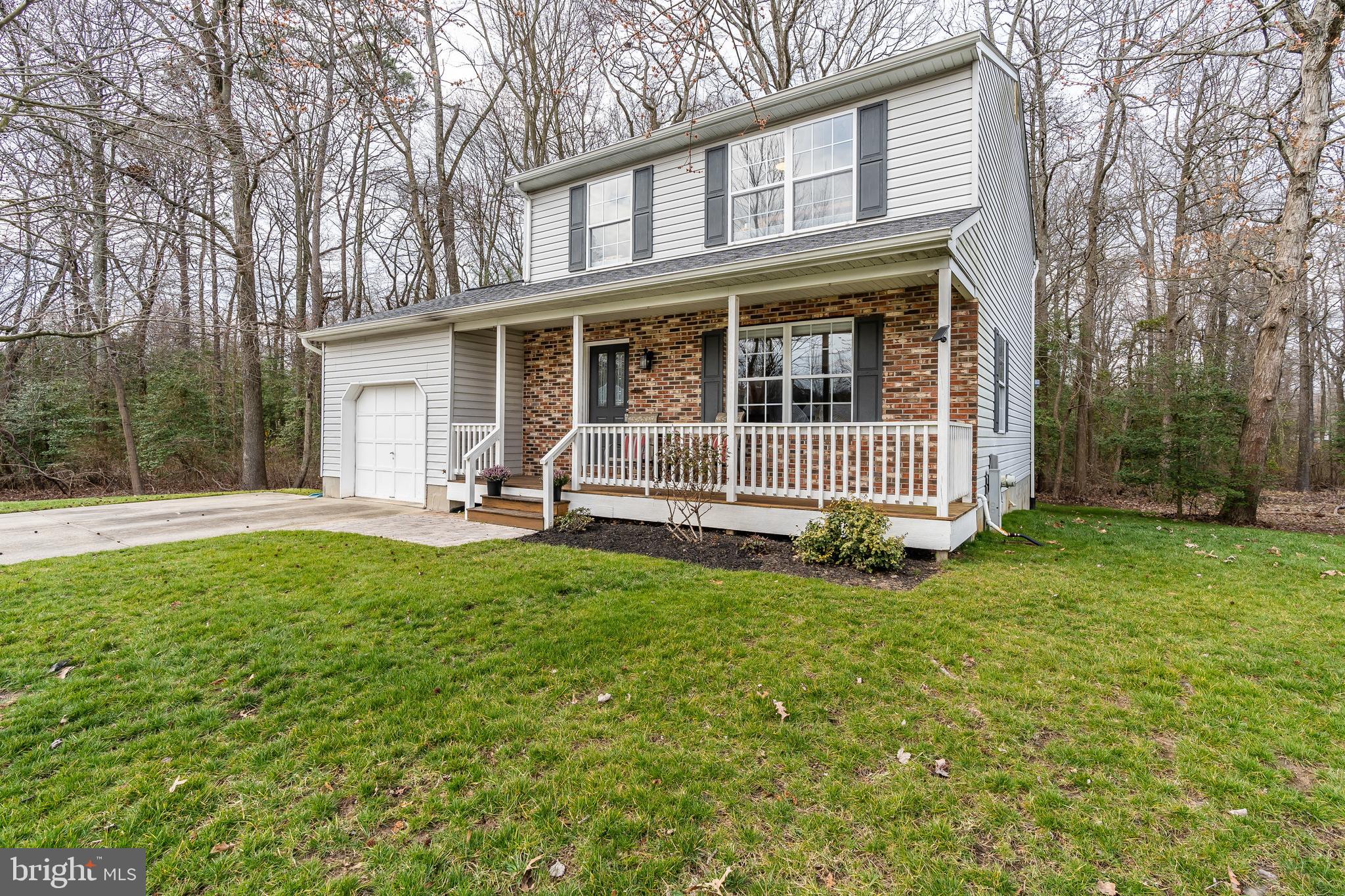 Beautiful colonial featuring 3 bedrooms, 2 full bath and 2 half baths.  Upgrades include a remodeled kitchen with stainless appliances, hardwood floors throughout the main level, fully finished lower level with 2 year new carpet and a wall-mounted tv that conveys.  The master bedroom has a large closet and en suite bath.  All plumbing replaced in 2016.  New roof in 2014 with a 10 year transferable warranty.  In addition to the lovely front porch, there is a large back deck with a wooded view that is perfect for entertaining or enjoying a quiet moment.  Finish it up with an attached garage and large parking pad, this home is Howard Manor living at its best.