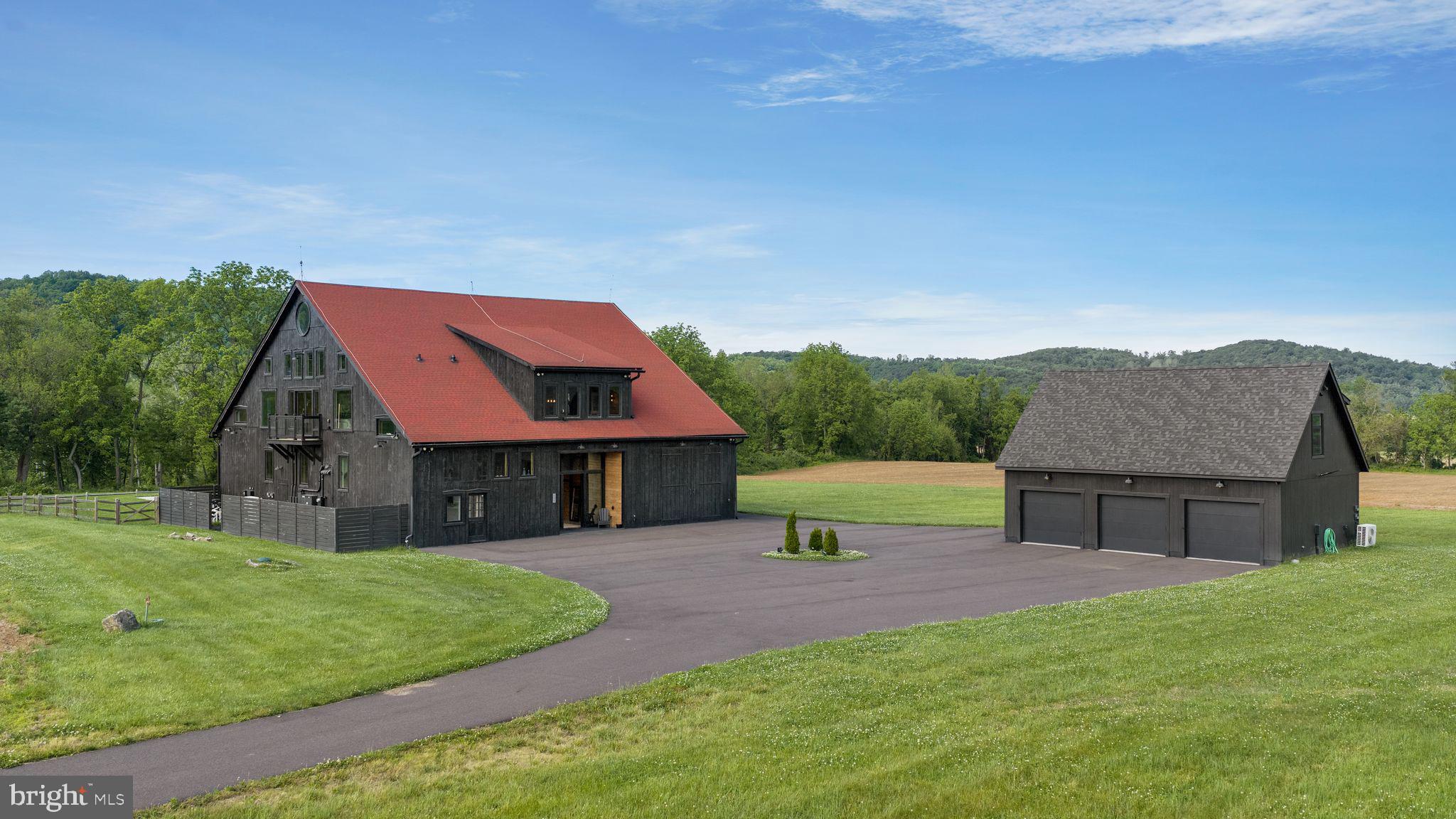 A truly one-of-a-kind offering, this extraordinary converted barn estate seamlessly blends the warmth of a traditional farmhouse with refined modern design, all set across 89 breathtaking acres of rolling hills, lush greenery, and panoramic countryside views. Thoughtfully reimagined with an uncompromising attention to detail, the five-bedroom, eight-bathroom residence is surrounded by captivating natural beauty, where spectacular sunsets paint the landscape and every window frames a picturesque vista. A recently constructed detached garage with a private one-bedroom, one-bath guest apartment further enhances the property's versatility.

Inside, soaring 24-foot vaulted ceilings, original wood beams, rich hardwood floors, oversized custom windows, and designer LED lighting create a warm yet sophisticated atmosphere. The sprawling great room serves as the heart of the home, anchored by a wood-burning fireplace and a dramatic wall of windows that floods the space with natural light. Designed for both everyday living and entertaining, the chef’s kitchen features a generous eat-in center island, butcher block and stainless-steel countertops, premium stainless-steel appliances, including a six-burner gas range, a walk-in pantry, and a seamless connection to the dining area. The serene primary suite is complete with a spa-inspired bath featuring a soaking tub overlooking the grounds, dual vanities, and two spacious walk-in closets. Additional highlights include a loft, expansive guest accommodations, multiple outdoor decks, a large laundry room, and a six-car tandem garage.

Created for effortless indoor-outdoor living, the estate’s resort-inspired grounds are an entertainer’s dream. Enjoy a heated swimming pool with a sun shelf, hot tub, pool house, and fenced yard, all surrounded by sweeping views of the countryside. Despite its exceptional privacy and peaceful setting, the property remains just moments from local restaurants, shops, and vineyards.