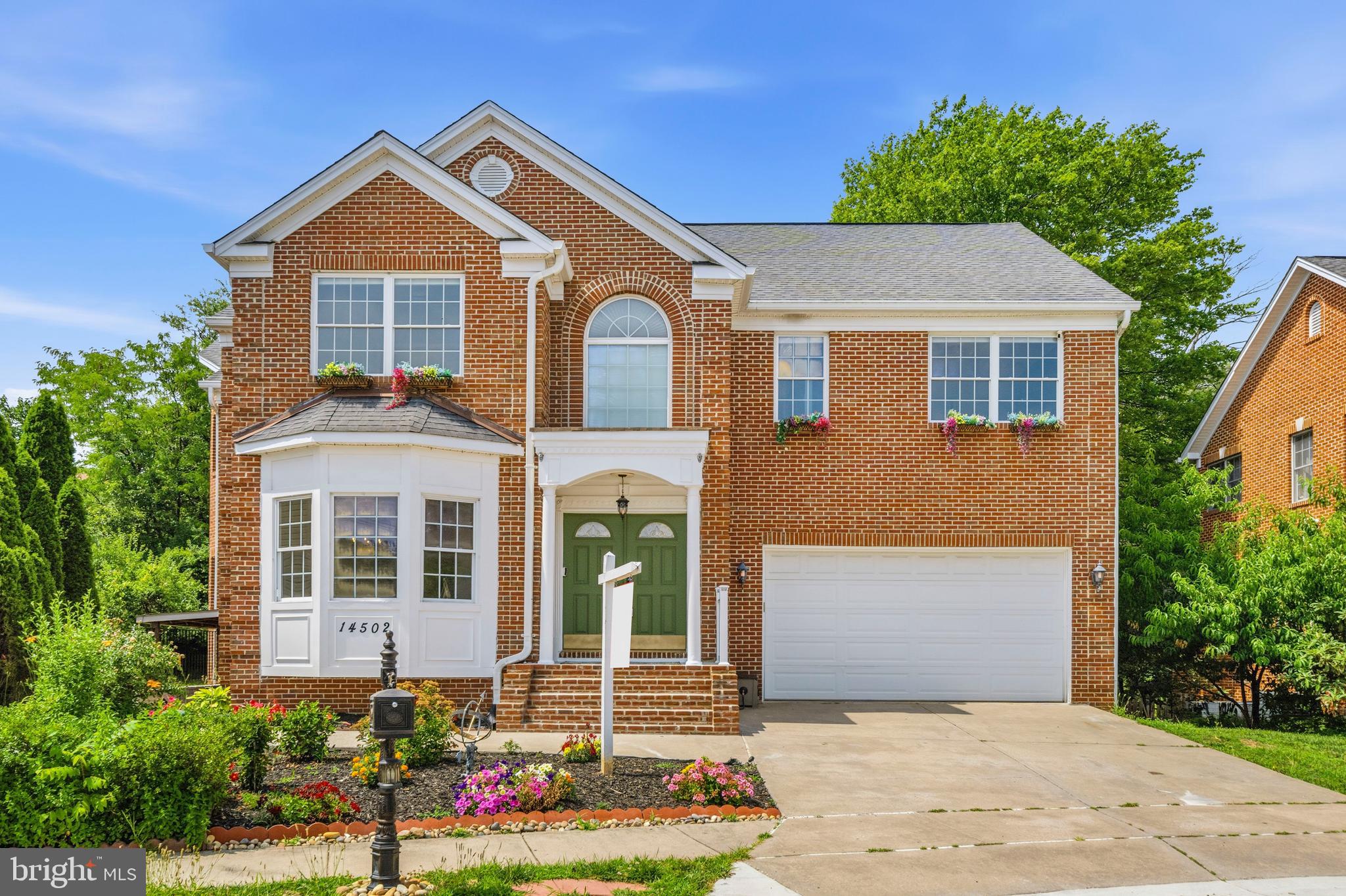 Prepare to be impressed by the design, layout, and space of this 5-bedroom, 4.5-bathroom colonial home. Positioned within a peaceful cul-de-sac and backing directly to trees, this home boasts over 4,300 square feet of living space. Complete with a two-car garage and newly updated front steps, this property offers excellent space and flexibility with NO HOA fees or restrictions. Step through the front door into a bright foyer showcasing a 22-foot ceiling that creates an open introduction to the home. The main level features 11-foot ceilings throughout, six-panel doors, fresh paint, and rich cherry hardwood flooring. Built with an open-concept flow, the main floor seamlessly connects a living room with bay styled windows into a dining room accented by columns, a stunning glass chandelier, and crown molding. The large family room offers a comfortable gathering space with a glass ceiling fan chandelier and additional bay-style windows. The large, table-space kitchen features cherry hardwood floors, distinctive teal cabinets topped with crown molding, stainless steel appliances, and premium granite countertops, a large matching island, and a granite backsplash. Sliding glass doors lead out from the kitchen to a freshly sanded and painted deck. From the deck, a stairway leads down to the backyard and a gorgeous new 34x16 stamped concrete patio backing to a private tree line. A home office with custom built-in wood-and-glass cabinets and bookshelves, a half bath with a pedestal sink, and convenient garage access complete the main floor. The upper level is finished entirely with oak hardwood floors. The primary suite serves as a spacious retreat, featuring bay-style windows, a large walk-in closet, and three glass ceiling fan chandeliers. The attached primary bathroom includes marble tile flooring and a matching tub surround, two single vanities, a separate shower, a jetted soaking tub, and two linen closets. The secondary bedrooms are well-proportioned; Bedroom 4 includes its own attached full bathroom, while Bedroom 3 offers direct access to the full hall bath. This level also features a dedicated laundry closet equipped with a front-loading Samsung washer and dryer, a laundry sink, and a pull-down attic stair resides in the hall ceiling. The fully finished walk-up basement is designed with high ceilings and luxury vinyl plank flooring throughout. This versatile area includes a large recreation room, a legal 5th bedroom with two windows and a closet, a full bathroom, and two separate bonus rooms with closets that are ideal for a home gym or media space. A newly added protective roof covering over the exterior walk-up stairway provides clean, convenient independent access to the lower level. Perfectly situated in a sought-after pocket of Burtonsville, this home offers a quiet suburban setting without sacrificing everyday convenience. Residents enjoy quick access to local parks, shopping centers, and dining options. The property is ideally located for commuters, sitting just minutes from the Intercounty Connector (ICC/MD-200), US-29, and I-95, providing direct routes to downtown Washington D.C., Baltimore, and the nearby employment corridors of Rockville and Silver Spring. ***Mortgage savings may be available for this listing.