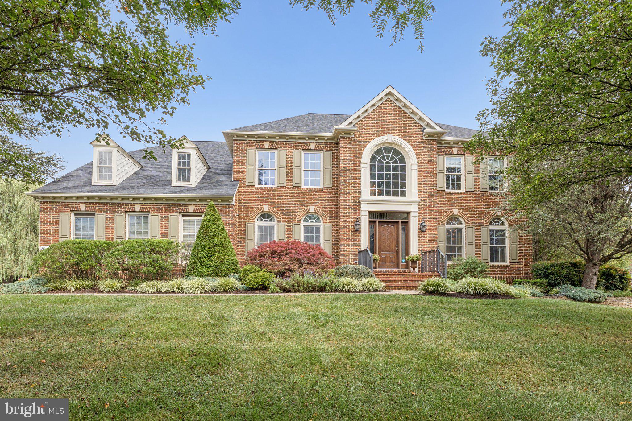 Welcome to 3028 Seneca Chief Trail in Ellicott City, a beautiful NV Homes Georgetown model offering 7,034 total square feet of living space, including a mostly finished basement, set on nearly one acre of wooded privacy. This home has been lovingly maintained by the original owners and showcases thoughtful updates throughout.

The main level impresses with soaring ceilings and a double staircase that flows from both the foyer and the kitchen. The gourmet kitchen was renovated in 2018 with quartz counters, white cabinetry, and stainless steel appliances, and opens seamlessly into the sunroom and spacious family room, making it perfect for entertaining. Off the sunroom, the backyard features a Trex deck completed in 2023 and back pavers installed in 2022. The main level also includes a large living room, dining room, private office with serene lawn views, laundry room, and a freshly carpeted family room featuring built-ins and a fireplace.

Upstairs offers four generously sized bedrooms. The primary suite includes a sitting room, two walk-in closets, and a large bath. A Jack and Jill suite connects two bedrooms with a shared bath, while the fourth bedroom has its own private bath. New carpet was just installed throughout the entire upstairs.

The walkout basement expands the living space with a large media room, a flex room with adjoining full bath, a unique custom-designed make-up/hair studio, and an unfinished storage and utility space with built-in cabinetry.

Additional highlights include a two-car garage with direct access to the laundry room, a driveway that accommodates five or more cars, a roof replaced three years ago with transferable warranty, two separate HVAC systems (furnace/AC for the main level and basement, heat pump for the upper level), nearly all fresh interior paint, and a washer and dryer that are only a couple of years old.

This home combines elegance, space, and privacy, all within a highly desirable Ellicott City location. It feeds into Manor Woods Elementary, Mount View Middle School, and Marriotts Ridge High School.  Open houses will be held Saturday and Sunday. Square footage is based on estimated floor plans provided by the photographer and may differ from public records. All measurements are approximate and should be independently verified.