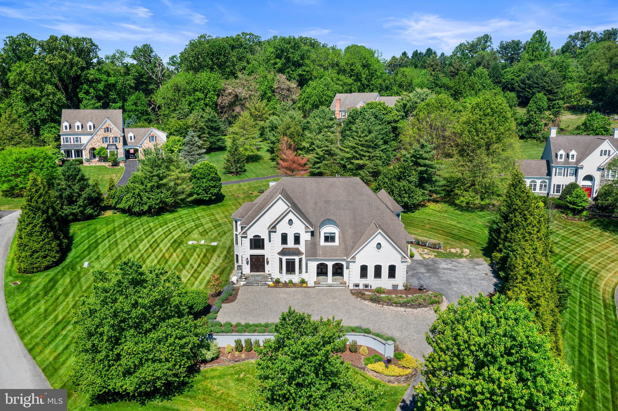 Welcome to 411 Red Clay Drive, an exceptional residence gracefully situated on a professionally landscaped 1.1+ acre lot. From the moment you arrive, the home’s impressive curb appeal, elegant hardscaping, and meticulous grounds set the tone for the luxury that awaits inside. Thoughtfully designed with both everyday comfort and entertaining in mind, this stunning home offers refined finishes and beautifully curated living spaces throughout.  At the heart of the home is a spacious kitchen designed for gathering, complete with abundant workspace and seamless flow into the banquet-sized dining room — perfect for hosting holidays, celebrations, and memorable evenings with family and friends. The expansive finished lower level is truly an entertainer’s dream, featuring multiple recreation areas ideal for pool, darts, pinball, board games, or relaxing in the private home theater.  When it’s time to unwind, the home offers a variety of inviting spaces to relax and recharge. Enjoy a quiet morning in the charming front sitting room, gather in the bright living room with soaring vaulted ceilings, or retreat to the peaceful garden patio for a summer evening under the stars.  The luxurious Owner’s Suite serves as a private sanctuary, filled with beautiful natural light and designed for ultimate comfort. The spa-inspired en suite bath features an oversized walk-in shower, deep soaking tub, dual vanity space, and generous walk-in closets.  Finished with exceptional attention to detail and timeless elegance throughout, 411 Red Clay Drive offers a rare opportunity to own a truly remarkable home that seamlessly blends sophistication, comfort, and entertainment. This is a must-see property.