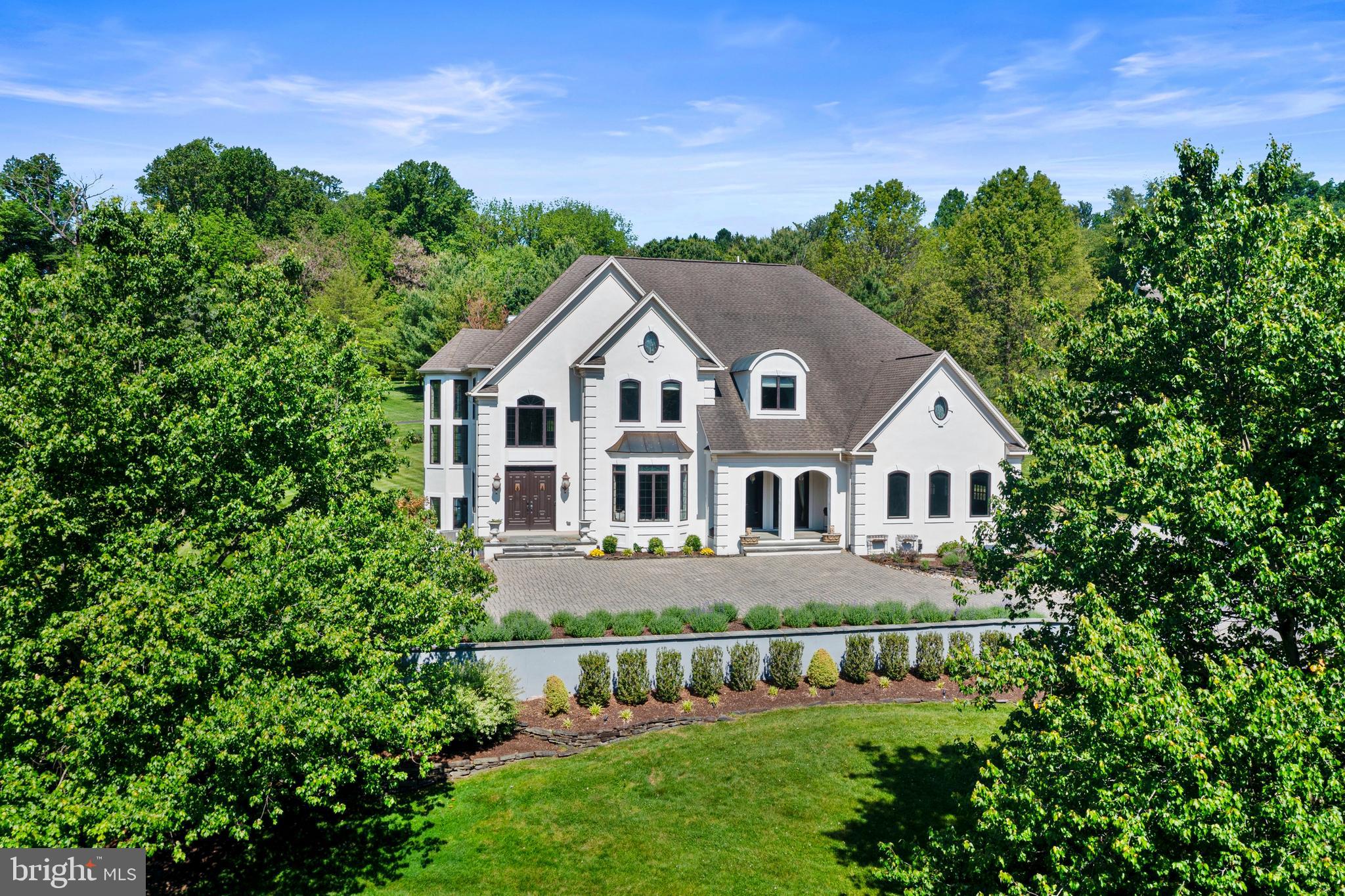 Welcome to 411 Red Clay Drive, an exceptional residence gracefully situated on a professionally landscaped 1.1+ acre lot. From the moment you arrive, the home’s impressive curb appeal, elegant hardscaping, and meticulous grounds set the tone for the luxury that awaits inside. Thoughtfully designed with both everyday comfort and entertaining in mind, this stunning home offers refined finishes and beautifully curated living spaces throughout.  At the heart of the home is a spacious kitchen designed for gathering, complete with abundant workspace and seamless flow into the banquet-sized dining room — perfect for hosting holidays, celebrations, and memorable evenings with family and friends. The expansive finished lower level is truly an entertainer’s dream, featuring multiple recreation areas ideal for pool, darts, pinball, board games, or relaxing in the private home theater.  When it’s time to unwind, the home offers a variety of inviting spaces to relax and recharge. Enjoy a quiet morning in the charming front sitting room, gather in the bright living room with soaring vaulted ceilings, or retreat to the peaceful garden patio for a summer evening under the stars.  The luxurious Owner’s Suite serves as a private sanctuary, filled with beautiful natural light and designed for ultimate comfort. The spa-inspired en suite bath features an oversized walk-in shower, deep soaking tub, dual vanity space, and generous walk-in closets.  Finished with exceptional attention to detail and timeless elegance throughout, 411 Red Clay Drive offers a rare opportunity to own a truly remarkable home that seamlessly blends sophistication, comfort, and entertainment. This is a must-see property.