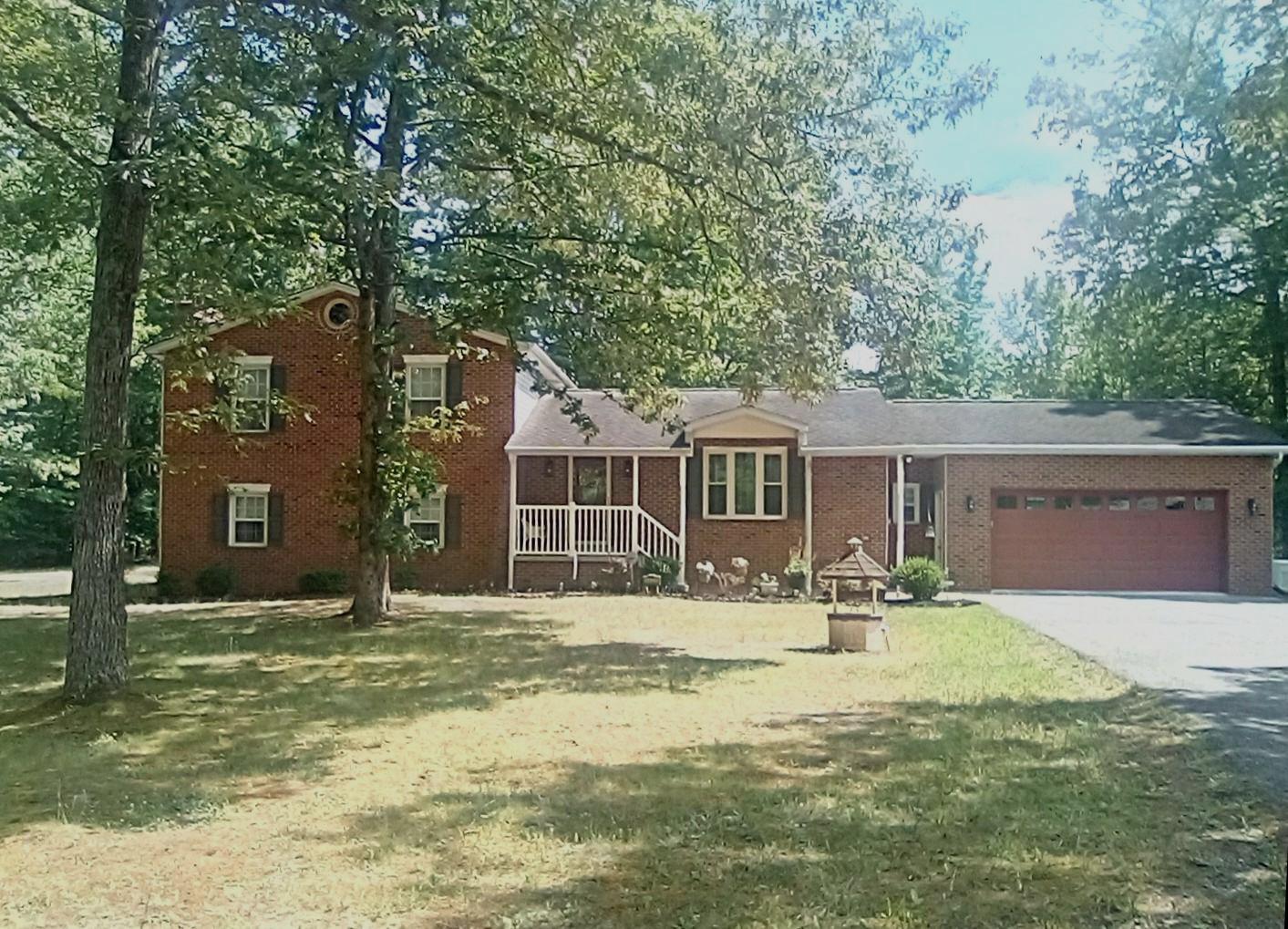 ENJOY COUNTRY LIVING WITH SCHOOLS AND SHOPPING NEARBY!  Experience the perfect blend of comfort and convenience in this delightful home, where every detail has been thoughtfully considered for your enjoyment. Welcome to this beautifully updated home that includes an oversized attached 2-car garage plus an oversized detached 2-car garage with 9-foot doors for taller vehicles, a 14x28 foot garage/shed with loft space and an additional shed for lawn equipment. This home offers tons of storage space for mechanics, car collectors, crafts and hobbies. A whole house generator provides backup power. The many features of this home also include hardwood and ceramic tile flooring, plus natural light that floods the space through skylights, enhancing the warm ambiance in the kitchen and sunroom. The heart of the home is the large, well-appointed kitchen, equipped with stainless steel appliances, 42-inch cabinets and granite countertops. A masonry fireplace with a gas insert awaits you in the spacious lower-level family room. Enjoy outdoor living on the expansive deck or screened gazebo, ideal for summer barbecues or quiet mornings with a cup of coffee. With a finished basement featuring a walkout entrance, this home offers endless possibilities. TAX ID 090612351 is also included with the property. The septic tank, furnaces and ductwork were cleaned in April 2026. *NO HOA* The owner is a licensed real estate agent. **A ONE-YEAR HOME WARRANTY IS PROVIDED**Call for details about how you can save when you finance your dream home with special financing**
