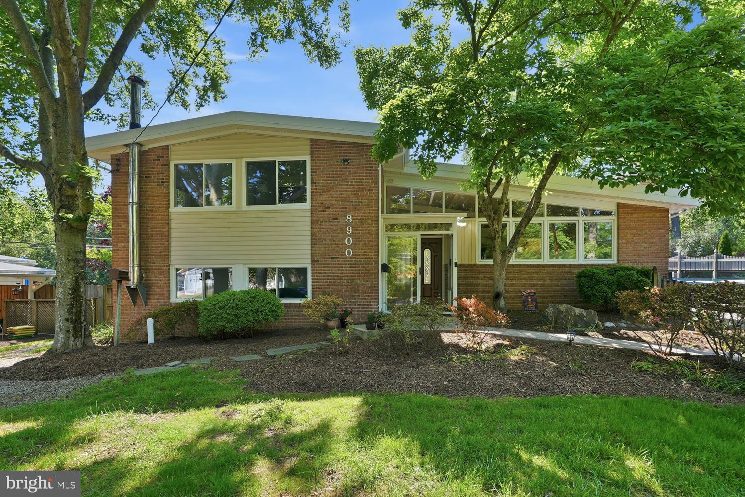 Some homes are designed for one season of life. This one is designed for all of them.
Thoughtfully expanded and professionally permitted, this Mid-Century Modern home offers 3,000 sq ft of remarkably flexible living space in one of Fort Hunt's most beloved neighborhoods. The standout feature is a fully independent upper-level living suite complete with its own kitchen, full bath, laundry, soaring vaulted ceilings, private deck, and exterior lift access.  A versatile space for long-term guests, a home office headquarters, creative studio, or private living quarters for generations.The main home blends classic contemporary design with warm natural materials, including rich oak trim, hardwood floors, a striking brick accent wall, recessed gas fireplace, and walls of windows that fill the living spaces with natural light. At the heart of it all, the beautifully updated kitchen with gas cooking flows seamlessly into the dining room overlooking the peaceful backyard, making everyday living and entertaining equally effortless.An oversized flex room connects the main home to the upper-level suite, providing endless possibilities as a media room, library, workspace, fitness area, or additional lounge. The lower level offers even more flexibility with a spacious recreation room, an additional bedroom and full bath, dedicated craft or exercise room, climate-controlled workshop, and walk-out access to the landscaped backyard.Outside, mature landscaping creates a peaceful backdrop with plenty of room to personalize the outdoor space, while the quiet Fort Hunt community is known for its welcoming neighbors, holiday celebrations, and convenient location.Just minutes from the George Washington Memorial Parkway, Historic Mount Vernon, Fort Hunt Park, trails along the Potomac River, Hollin Hall pastry shop, and Costco. But also a 20 minute scenic commute to Fort Belvoir, the Pentagon, Reagan National Airport, and downtown DC. Floor plans in photos.