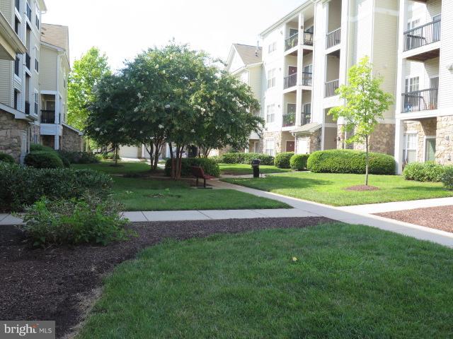 Gorgeous hardwoods and neutral paint.  Newer full size washer and dryer in unit. Updated vanity tops and fixtures.  2 Bedroom/2 Bath PLUS built-in desk/office area. 3 ceiling fans. Open kitchen w/newer gas range and microwave above plus plenty of cabinets/pantry. Seating at kitchen bar and in breakfast room. Living room mantled corner gas fireplace & sliding glass door to deck. Walk-in closets + linen closet. Assigned parking space + visitors pass. Gated community w/pool, gorgeous clubhouse, outdoor grill/patio areas, tot lot, and more.