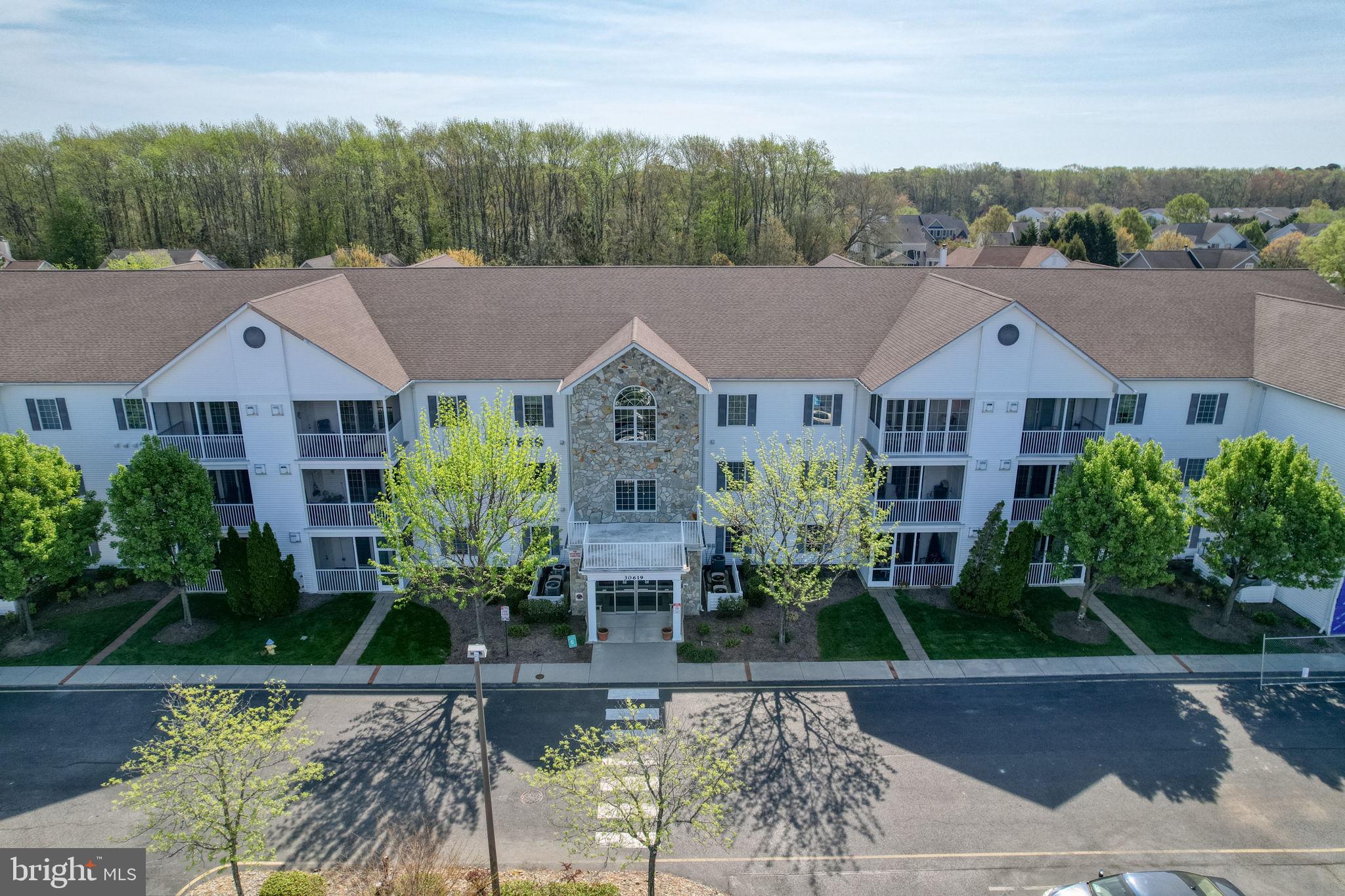 Back on the market through no fault of the Seller, due to a late change in Pet policy.  RARE Offering! This is the ONE you have been waiting for and must see! Spectacular high-end renovations and effortless coastal elegance define this stunning 3-bedroom, 2-bath condo - a 2nd floor corner unit residence in the sought-after Cedar Bay 55+ community—just 1.5 miles from the beach. Take the elevator to the 2nd floor and step inside to discover a beautifully reimagined interiors featuring a brand-new chef inspired kitchen with new gleaming quartz countertops, new stylish tile backsplash, new upgraded cabinetry, select new appliances and new ceramic tile flooring. The open floor plan flows seamlessly, enhanced by the new rich hickory hard wood floors that extend throughout the home, creating warmth and sophistication in every room. Perfectly positioned with a coveted south and east orientation, this serene corner unit is bathed in natural light. Expansive windows frame picturesque views of vibrant, colorful blossoming trees in spring, while the primary suite welcomes the gentle morning sun through its dual exposures—offering a peaceful start to each day. From the living room, and through the 3-panel sliding glass doors, step out onto your private screened balcony and take in the tranquil surroundings and coastal breezes - the perfect setting for morning coffee, evening cocktails, or simply unwinding after a day at the beach. Escape to your spacious primary suite with the south and east facing windows that welcomes in the morning sun - a private en-suite bathroom, complete with a walk-in shower, plus an ample walk-in closet.  There are comfortable size 2nd and 3rd bedrooms; one could serve as an office or craft room. Hallway full bathroom with a tub and shower combo. Convenient new LG washer / dryer stack. Plantation shutters on the windows. (New HVAC /Heat Pump being installed soon!) The condo is wheelchair accessible. Cedar Bay offers a relaxed yet active, carefree lifestyle with beautifully maintained grounds, an inviting outdoor pool, and a charming pool house. Ideally located near both the beach and bay - while also being in a quiet setting away from the crowds - with nearby nature trails for walking and enjoying the outdoors. Cedar Bay is a 55+ community: 80% of residents must be 55+. Secure building entrance. (Elevator building.) You deserve to enjoy the good life with no steps to climb, no lawn to cut, no exterior maintenance or repairs to do. A short walk to the Cheer Center to make & meet friends and enjoy its amenities. Lovely outdoor landscaped grounds to enjoy. Compare this attractive price for luxury, while being this close to the ocean and the bay! And close to the beach, boardwalk, tax-free shops, restaurants, grocery stores, medical, sports activities, outdoor concerts in summer, and all the essentials! This exceptional home combines luxury, comfort, and the very best of coastal living!