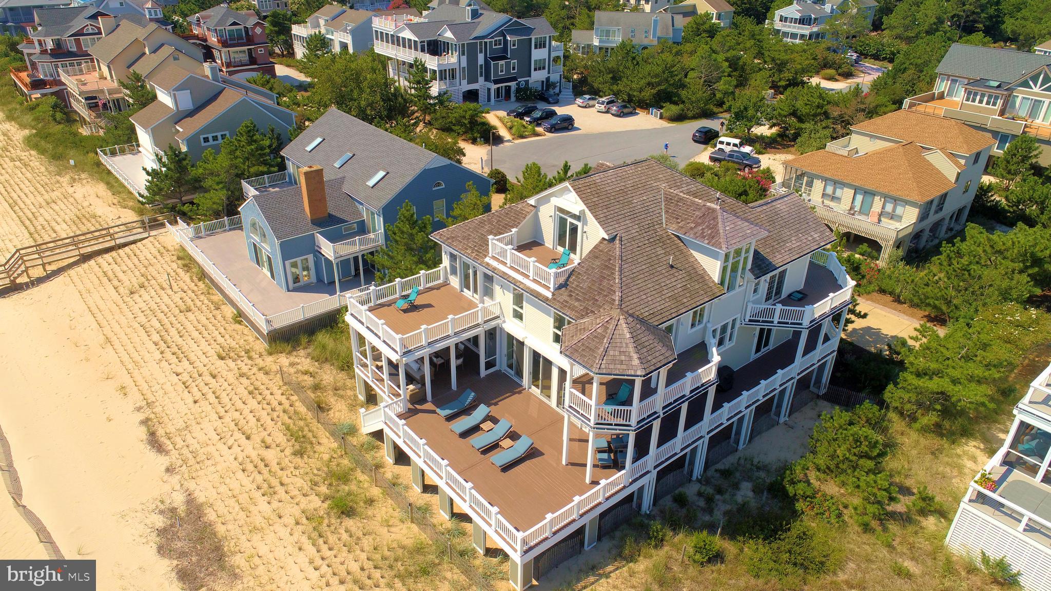 This is not your ordinary oceanfront beach retreat...  It is the most prominent, panoramic oceanfront view in North Bethany offering 10 foot oceanfront doors with floor to ceiling windows that showcase the sweeping 270 degree views.  Open generous floor plan for casual beach living and entertaining.  Don't just look out on the beach, look for miles up the beach from walkway to walkway in a rare bygone era panoramic picture.  Spacious warm bedrooms, private balconies, all en suite bathrooms, all of which have breathtaking beach and ocean views.  Full third floor private suite with kitchenette, fireplace, balcony and bar.  Many other up-graded features include butler's pantry, wine cooler, full 4 story elevator, reclaimed wood beams, sliding barn doors, multiple built in cabinets, floor to ceiling glass folding wall opening to a beautiful relaxing screened sun porch with operable screen panels for those crystal blue sky days at the beach.
