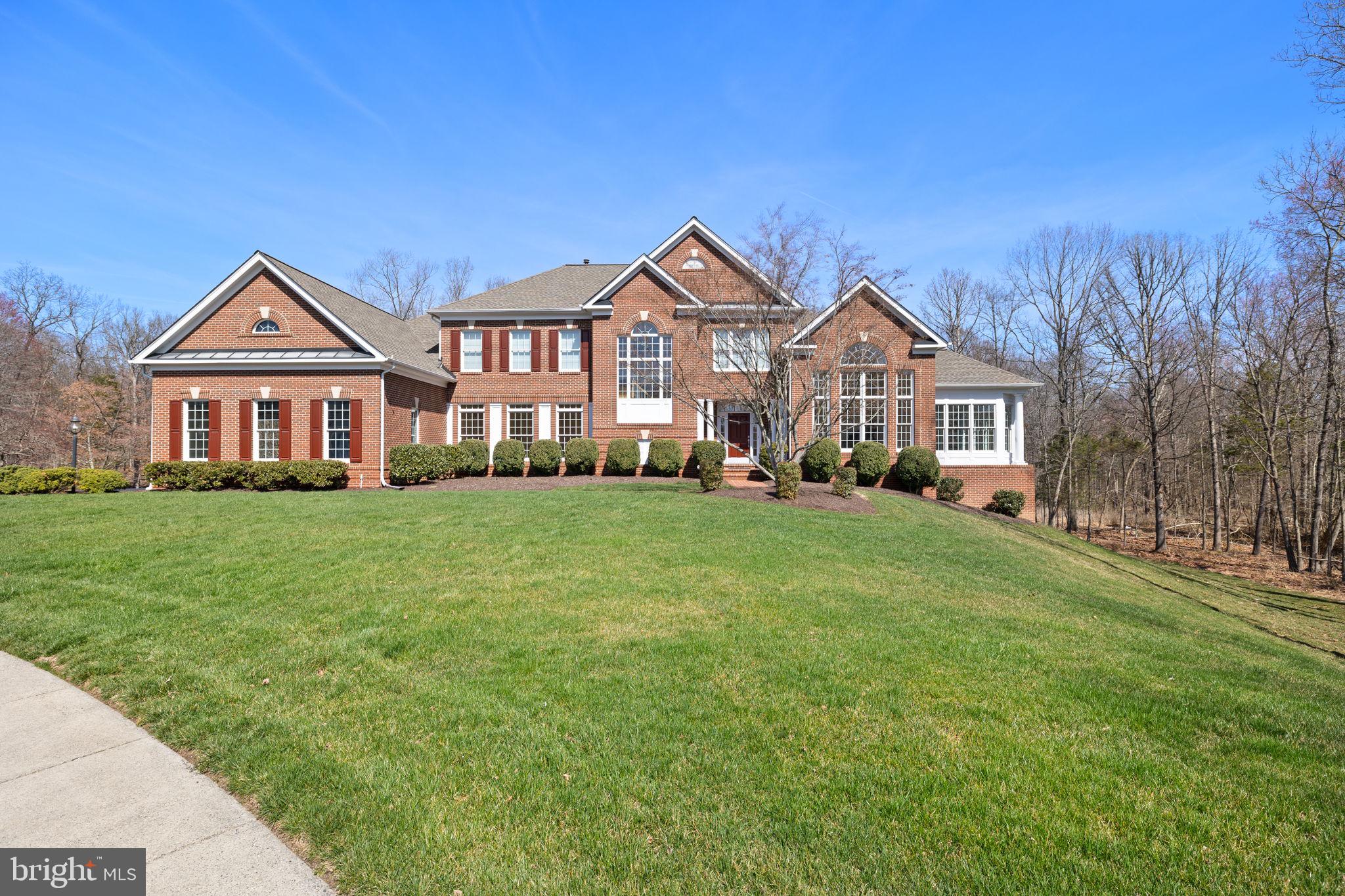 Welcome home to this breathtaking home on one of the best lots in the neighborhood! This home has been lovingly maintained by the original owner and is well situated on over 1.7 serene acres nestled on a cul de sac and backing to woods. This home exudes luxury and charm at every turn. As you enter, you'll be greeted by a grand foyer. From the spacious living room featuring a high, vaulted ceiling and a large Palladian window to the banquet-sized formal dining room, and main-level study, this home offers elegant spaces for entertaining.  The gourmet kitchen is a chef's delight offering top-of-the-line appliances, granite counters, plenty of cabinet space, a center island, and a walk-in pantry. Start your day in the sunroom or morning room overlooking your serene backyard oasis. The family room features a FP and built-ins and creates a relaxed atmosphere for everyday living. The study offers a cozy fireplace providing warmth and ambiance. (The study can even be turned into a main-level bedroom!) Enjoy the privacy and natural beauty from the low-maintenance Trex deck (only about 2 years old and never used!), perfect for entertaining or unwinding after a long day. The main level laundry room adds convenience and offers cabinet & counter space, and a second powder room. There are four spacious bedrooms upstairs providing ample space for family and guests, each with a full bathroom including the luxurious primary BR with a private sitting room, 2 walk-in closets, and a spa-like, ensuite bathroom. The walk-out basement features an expansive rec room with a third FP and custom wet bar, the fifth bedroom, a game room, a den, and a full bath. ALL WINDOWS have been upgraded to low maintenance, quality, series 400 Andersen including the large Palladian windows (over a $40K+ custom upgrade and lower electric bills!). All screens were replaced last year. All bathtubs were upgraded from fiberglass to cast iron. ALL HVAC UNITS WERE REPLACED WITHIN THE PAST 2 YEARS & THE ROOF WAS REPLACED ONLY A FEW YEARS AGO! This meticulously maintained home features extensive updates and reflects pride of ownership. The brick front adds a stately, timeless charm. This exceptional property offers privacy and tranquility while remaining just minutes away from everything you need. Amenity-rich Virginia Run community with basketball courts, tennis, pickleball courts, tot lots, pool, community center, and miles of trails. Easy access to commuter routes, dining, shopping, parks, & more!